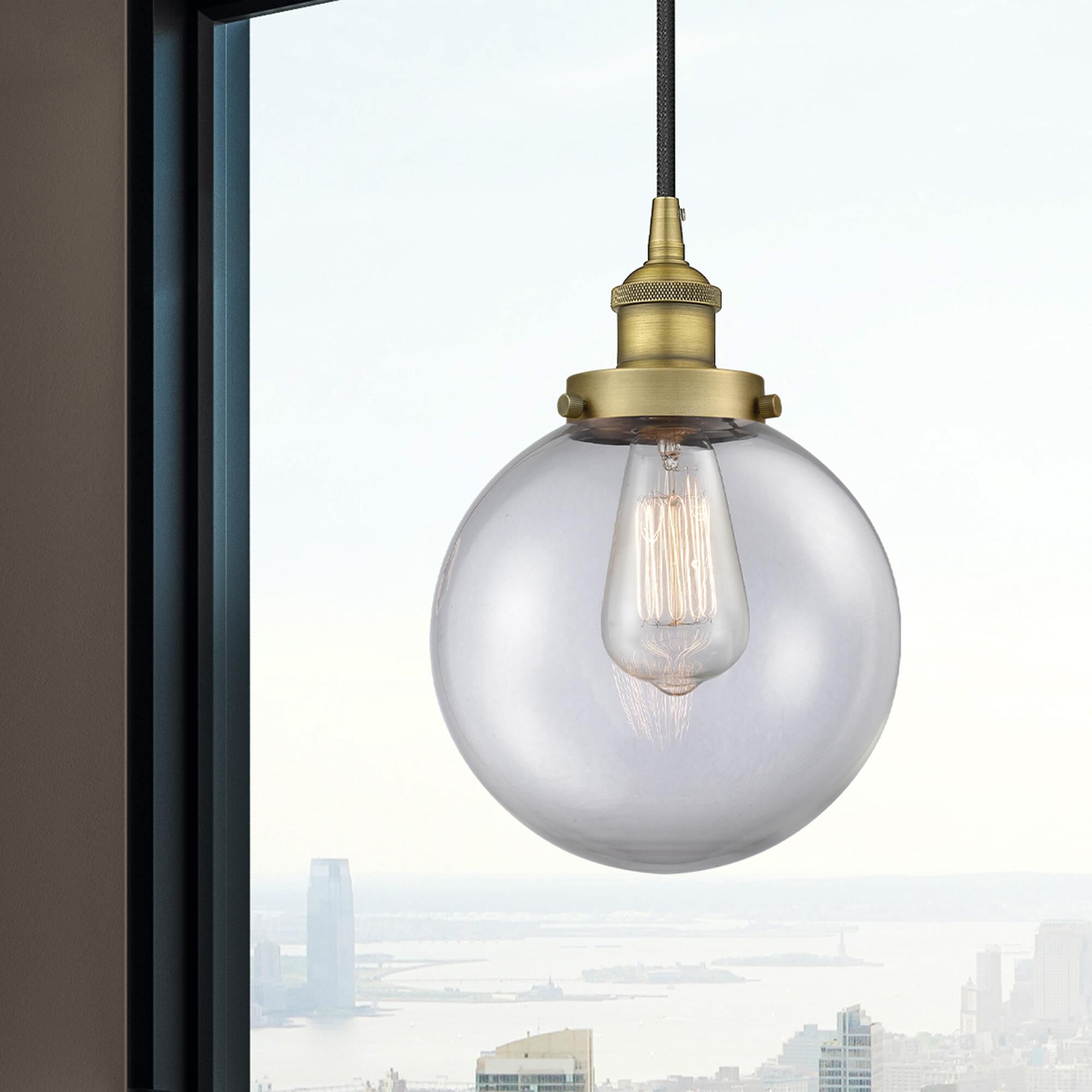 Shown in Brushed Brass finish and Clear Beacon glass