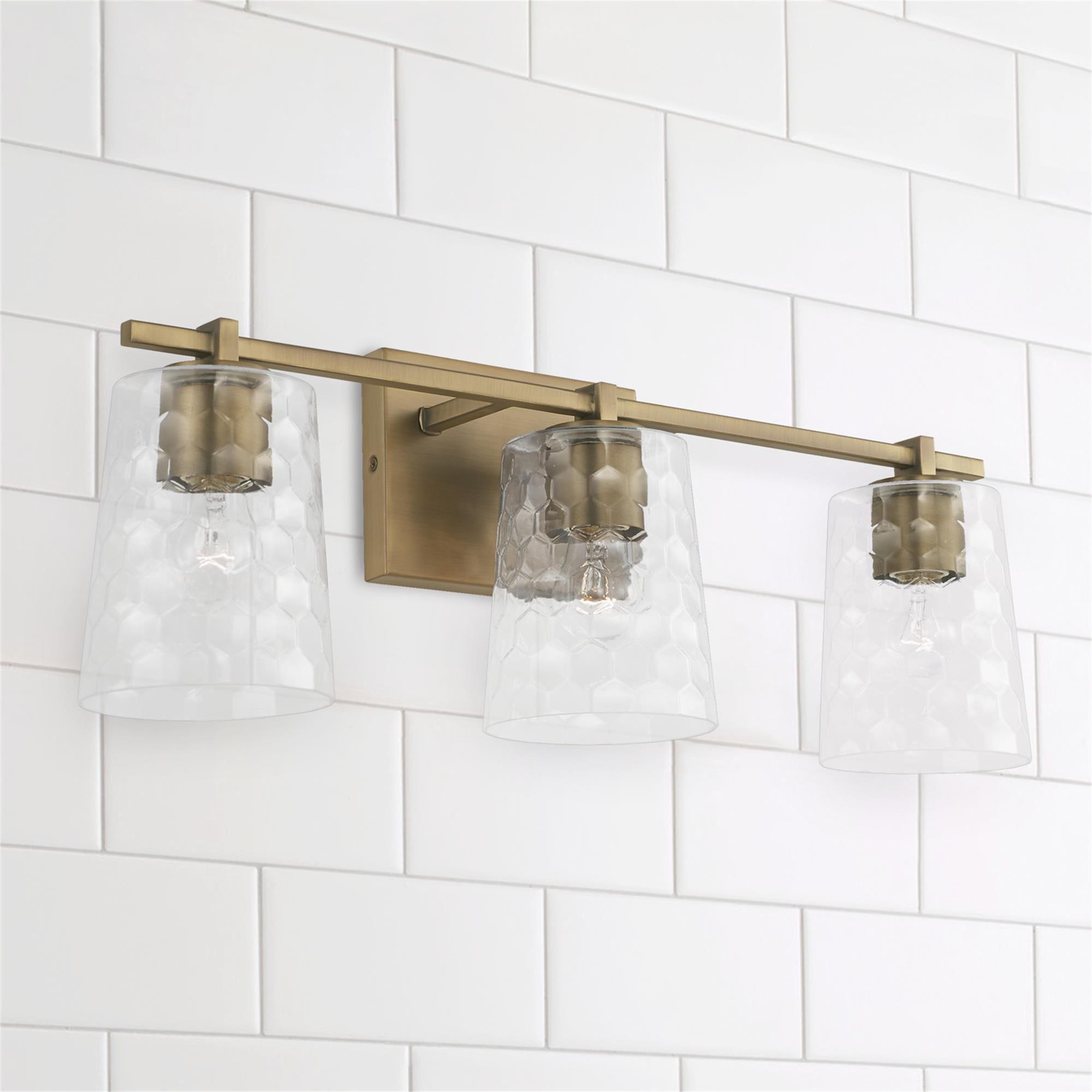Shown in Aged Brass finish and Clear Honeycomb glass