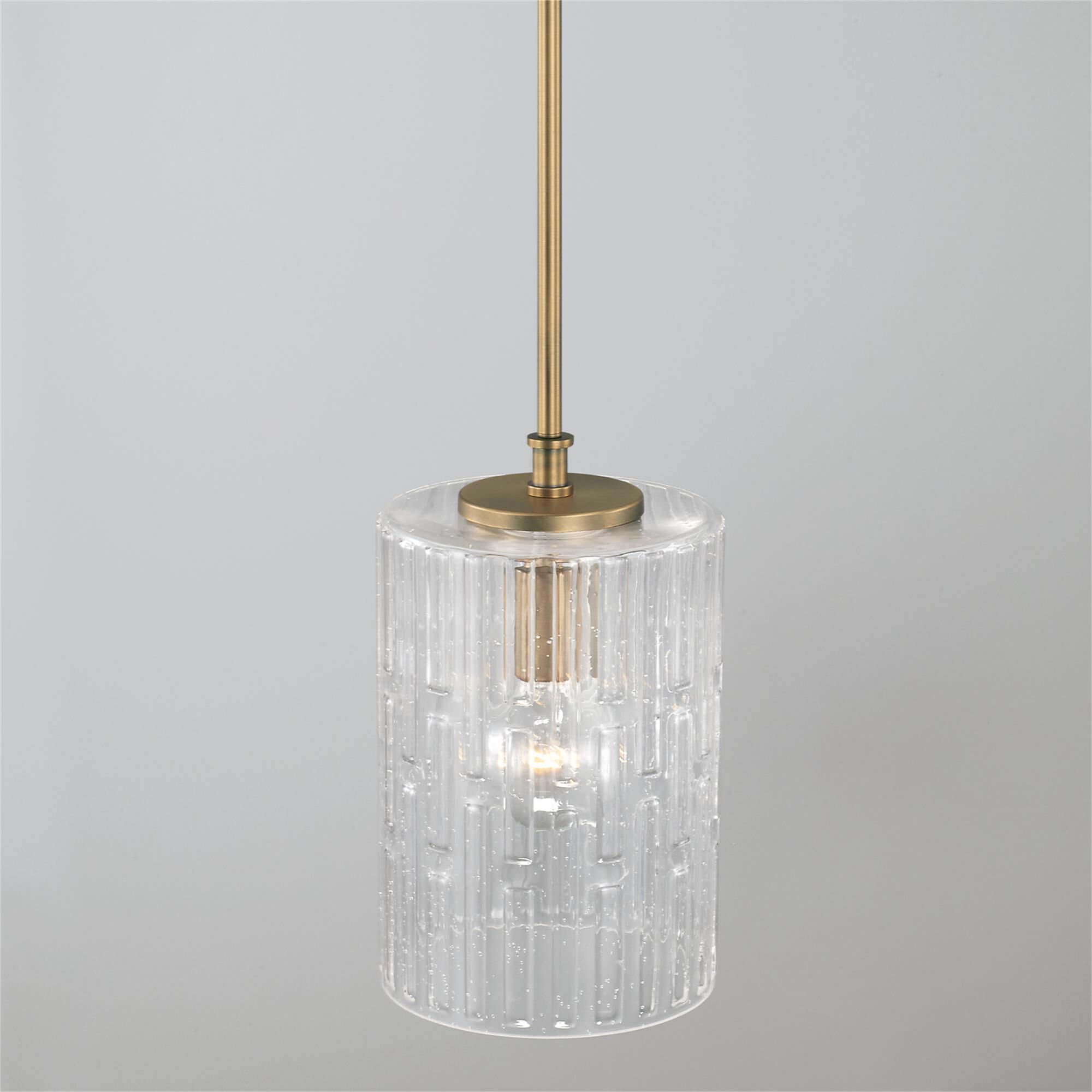 Shown in Aged Brass finish and Embossed Seeded glass