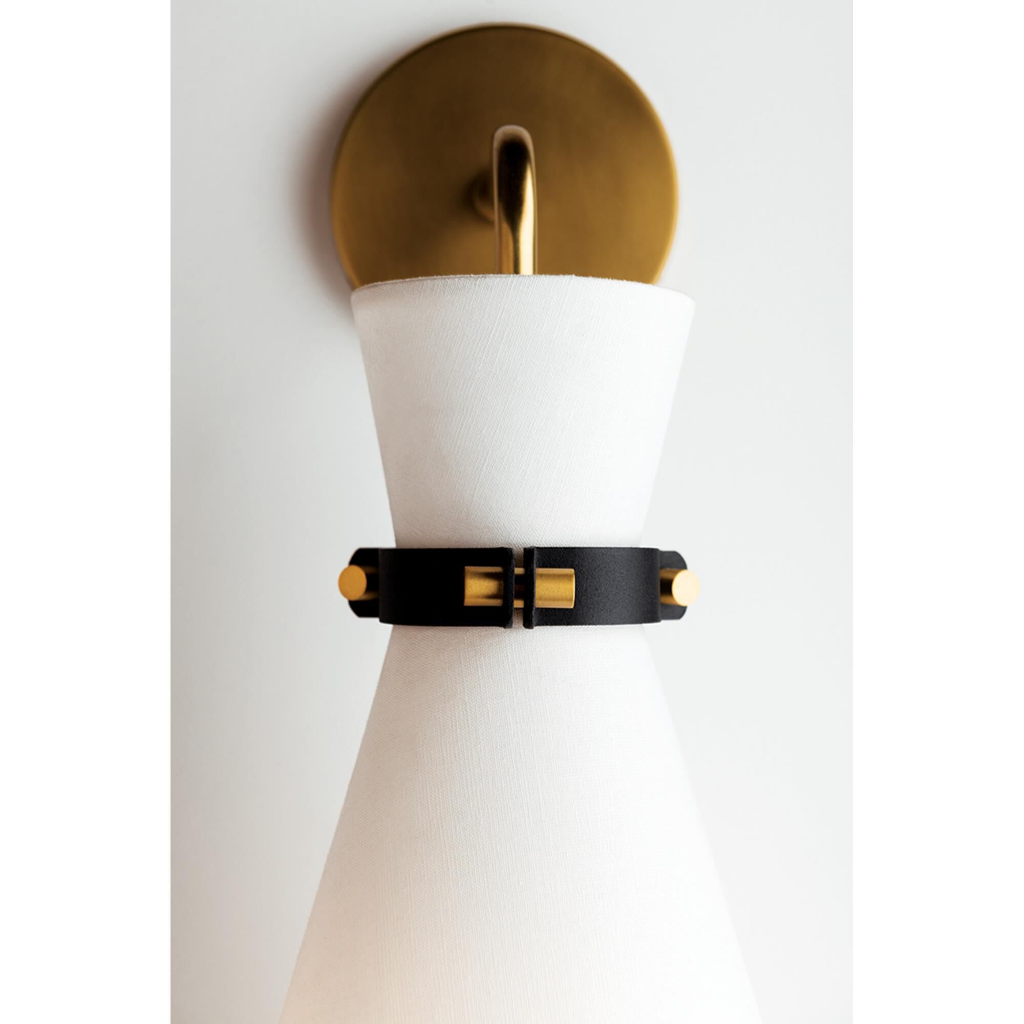 Shown in Aged Brass finish and White Linen shade and Black accent
