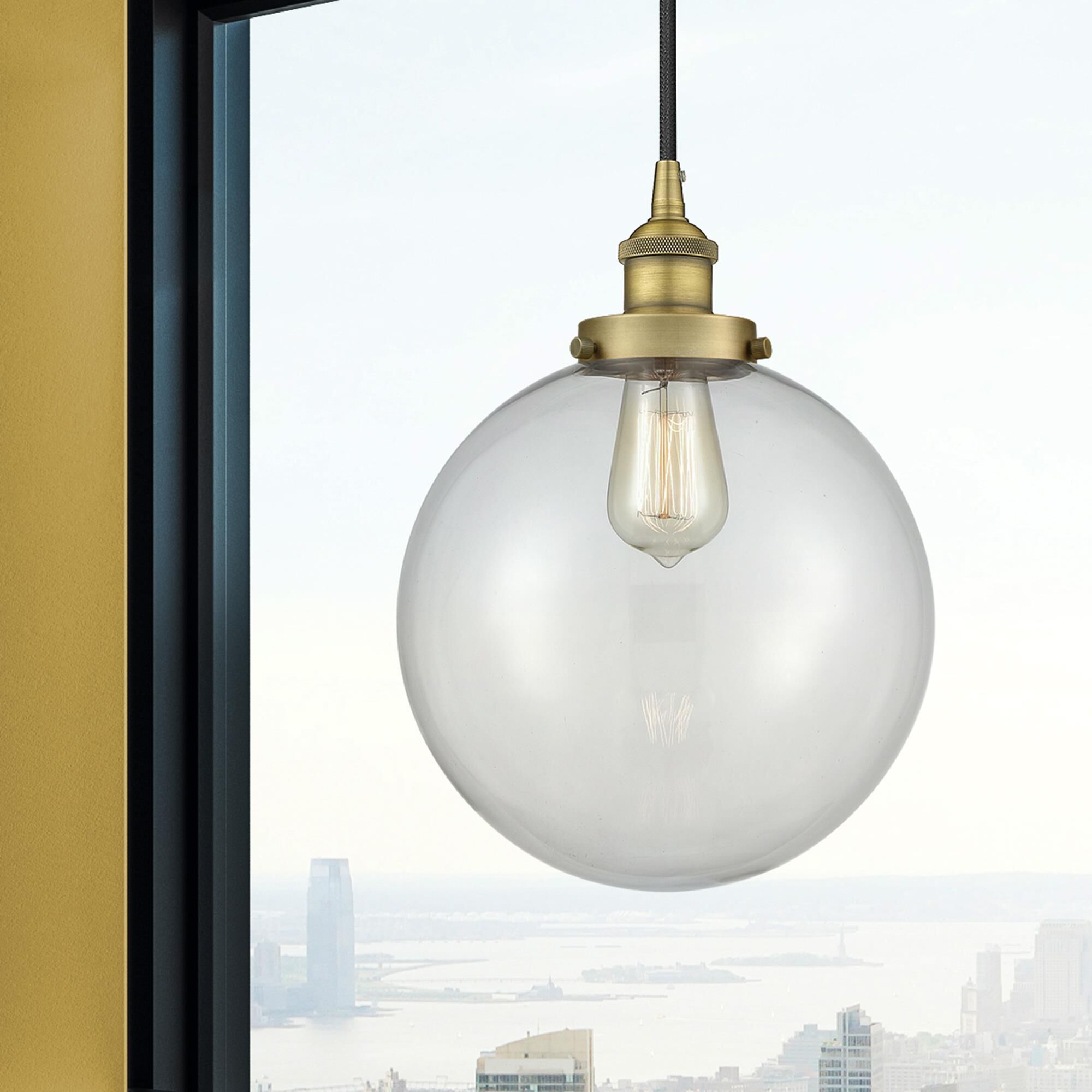 Shown in Brushed Brass finish and Clear Beacon glass
