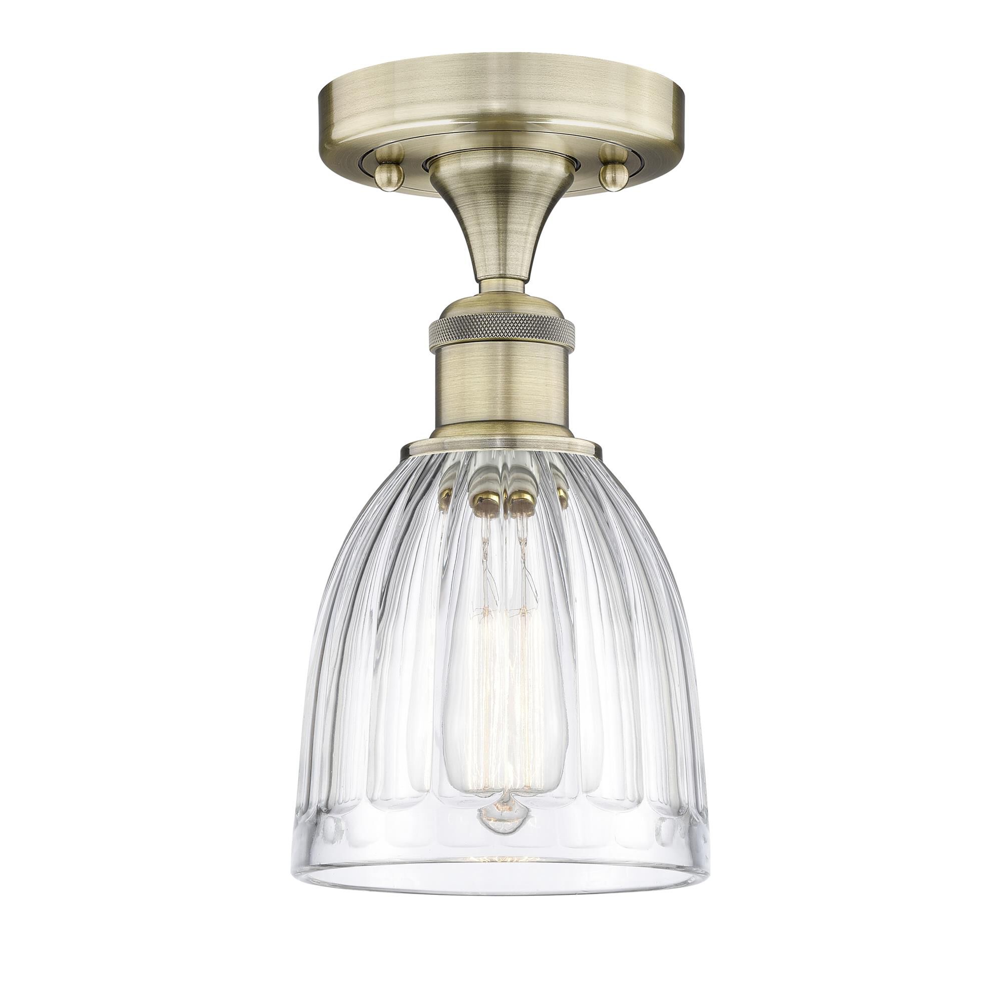 Shown in Antique Brass finish and Clear glass