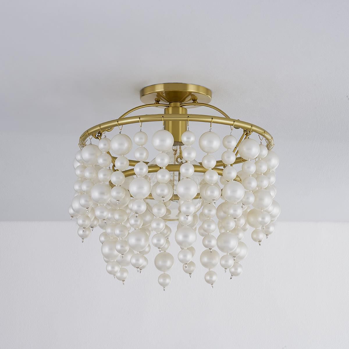 Shown in Aged Brass finish and Pearl glass