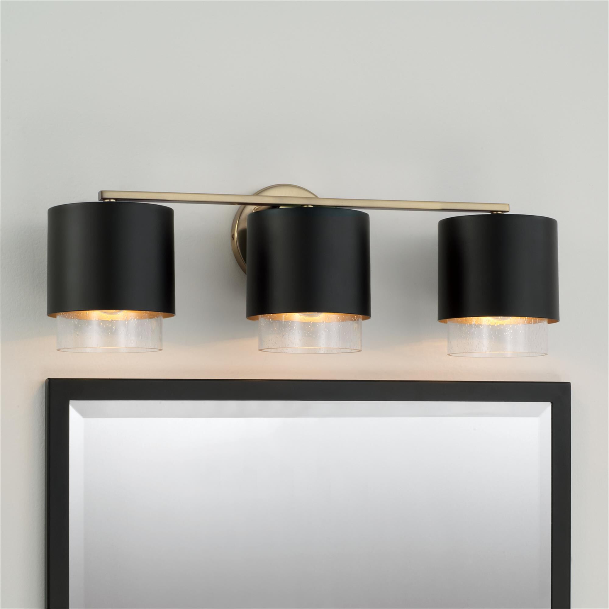 Shown in Matte Brass and Black finish and Clear Seeded glass and Metal with Brass Interior shade
