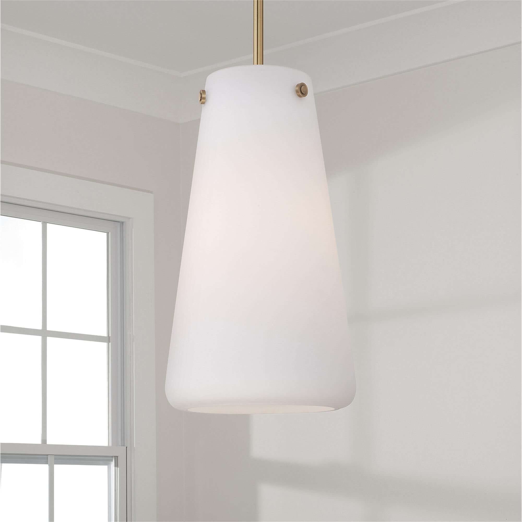Shown in Aged Brass finish and Soft White glass