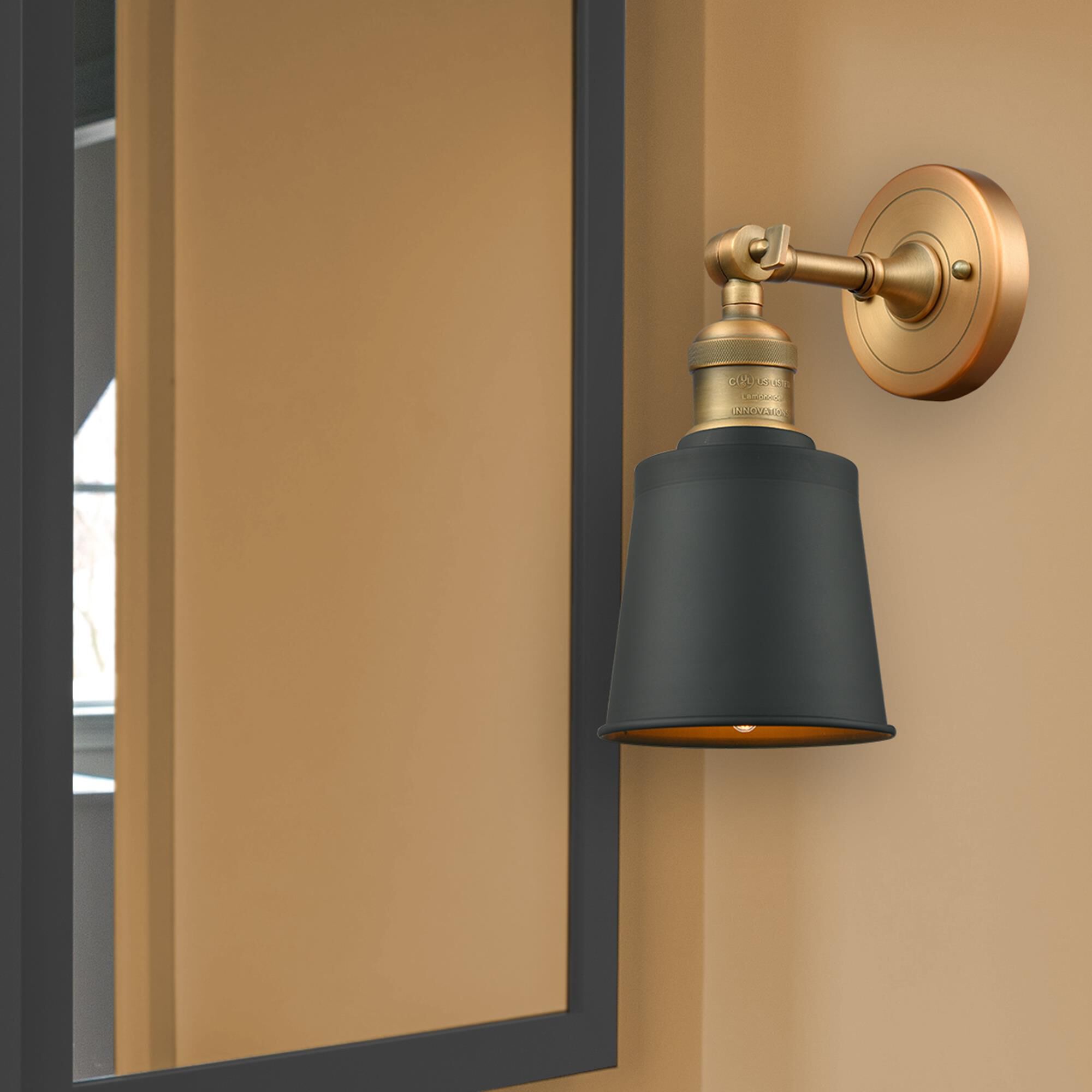 Shown in Brushed Brass finish and Matte Black Metal shade