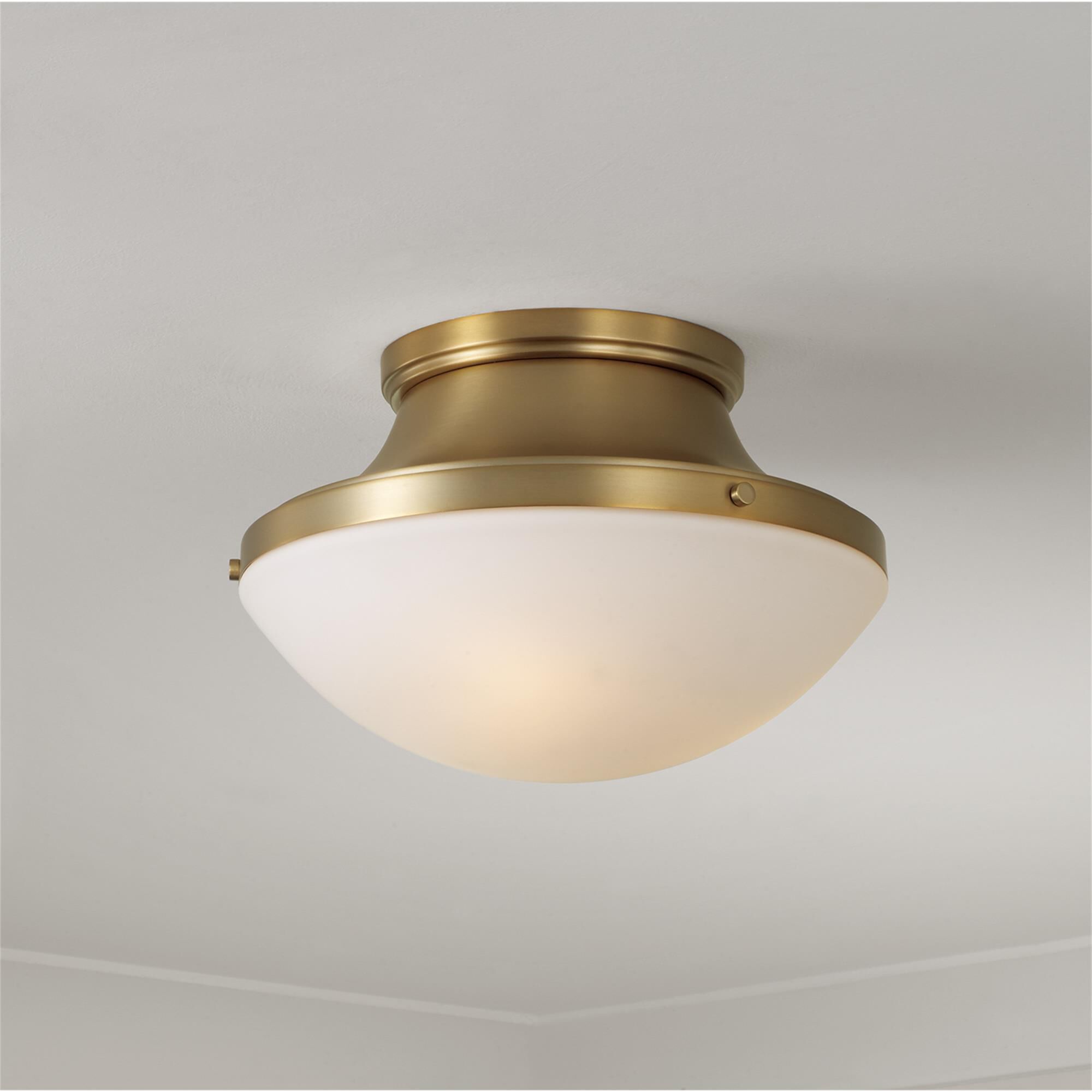 Shown in Aged Brass finish and Soft White glass