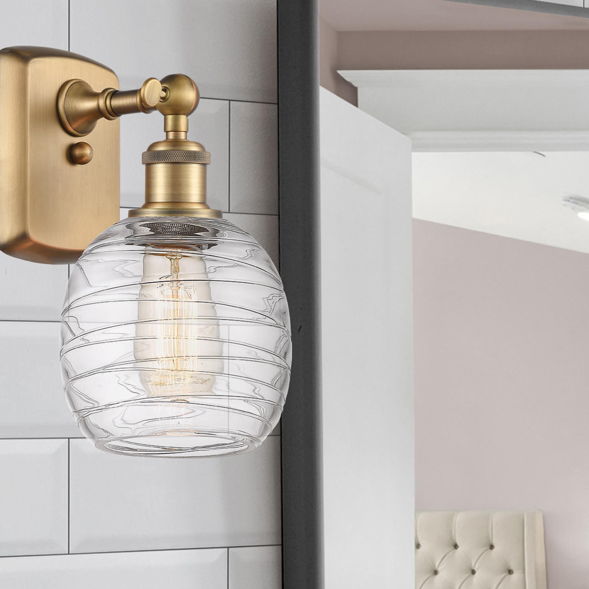 Shown in Brushed Brass finish and Deco Swirl glass