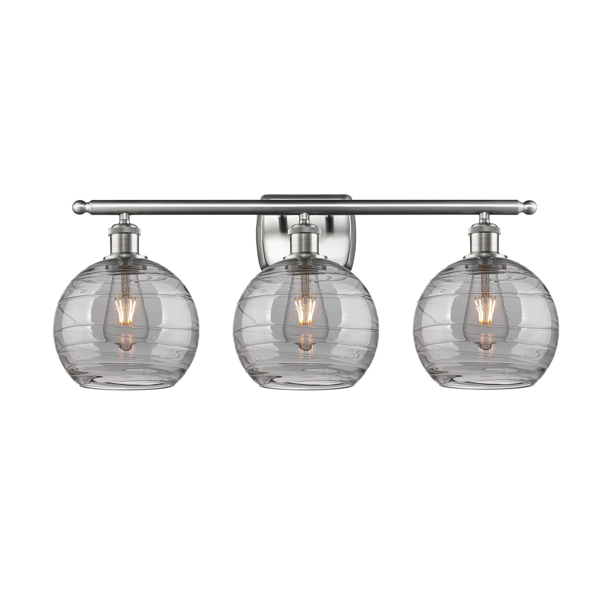 Shown in Brushed Satin Nickel finish and Light Smoke Deco Swirl glass