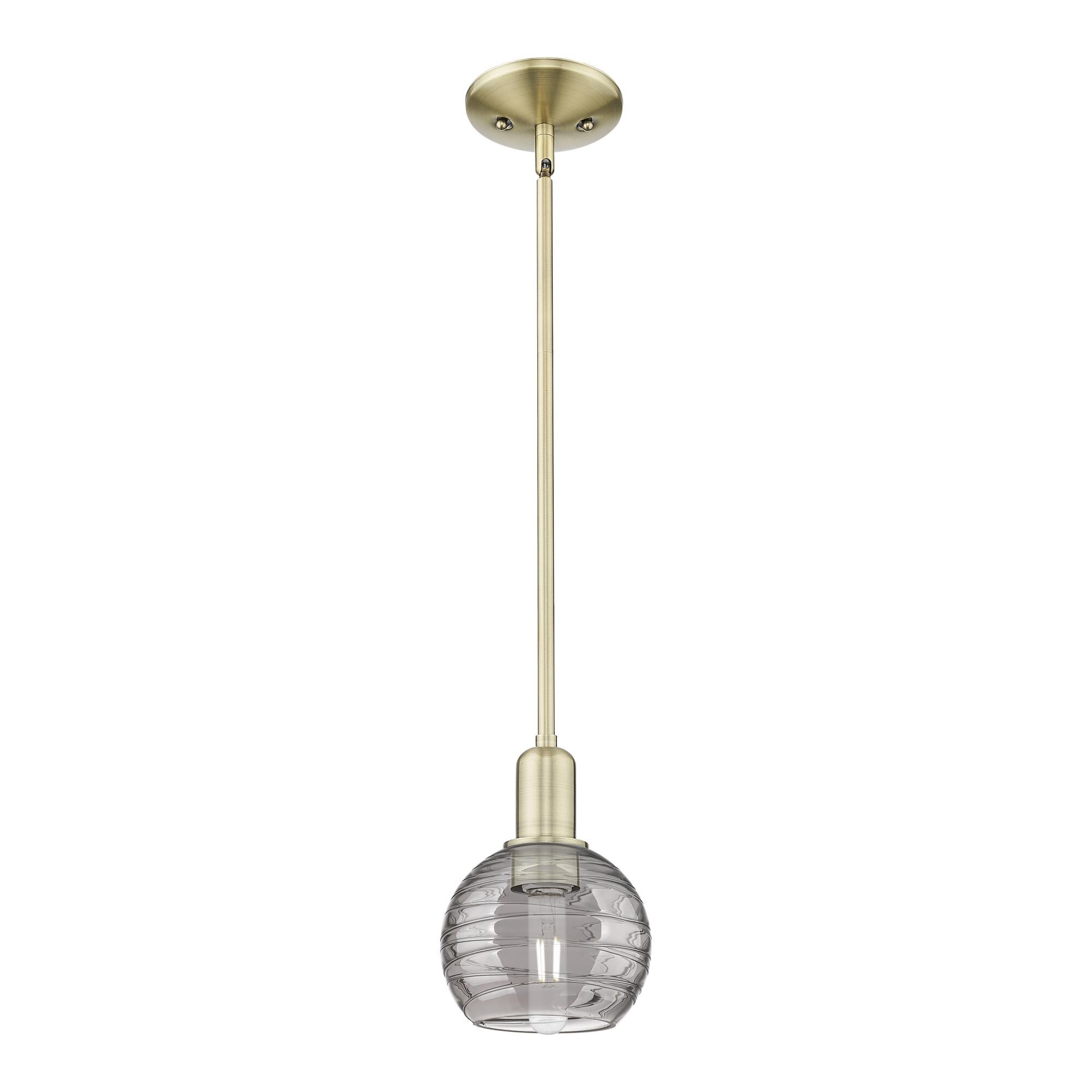 Shown in Antique Brass finish and Light Smoke Deco Swirl glass