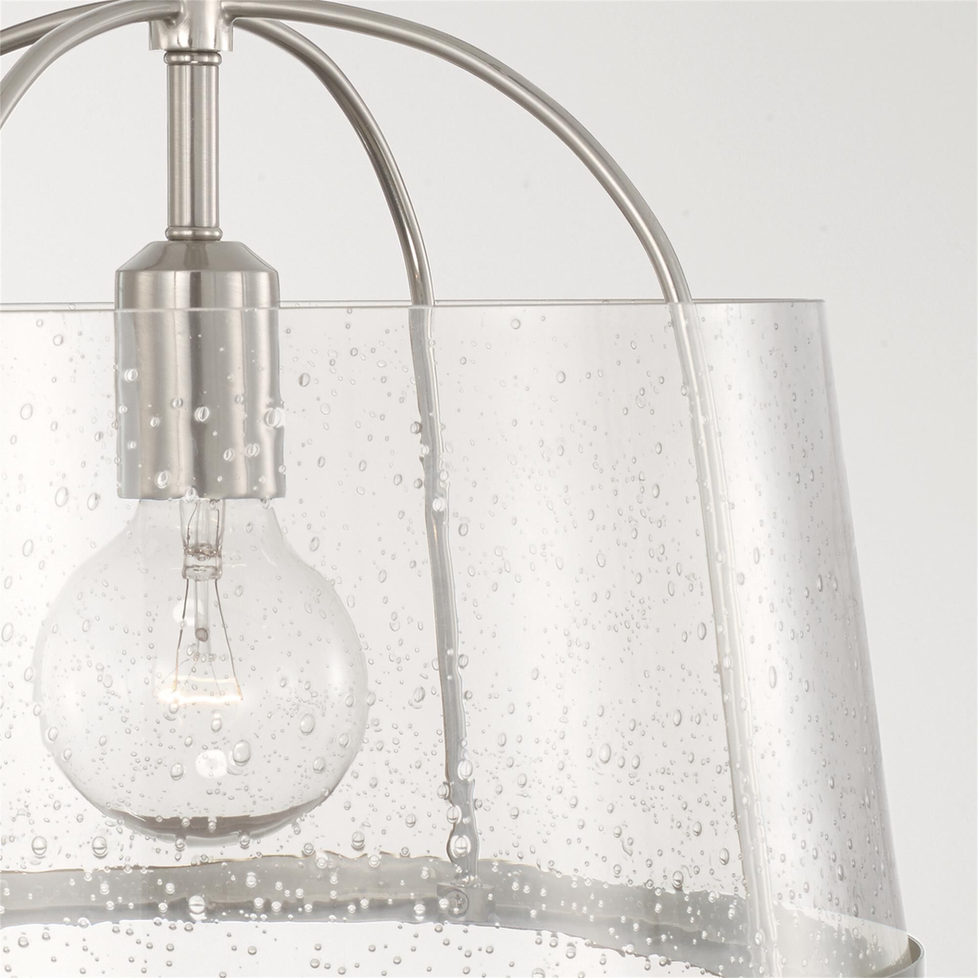 Shown in Brushed Nickel finish and Clear Seeded glass
