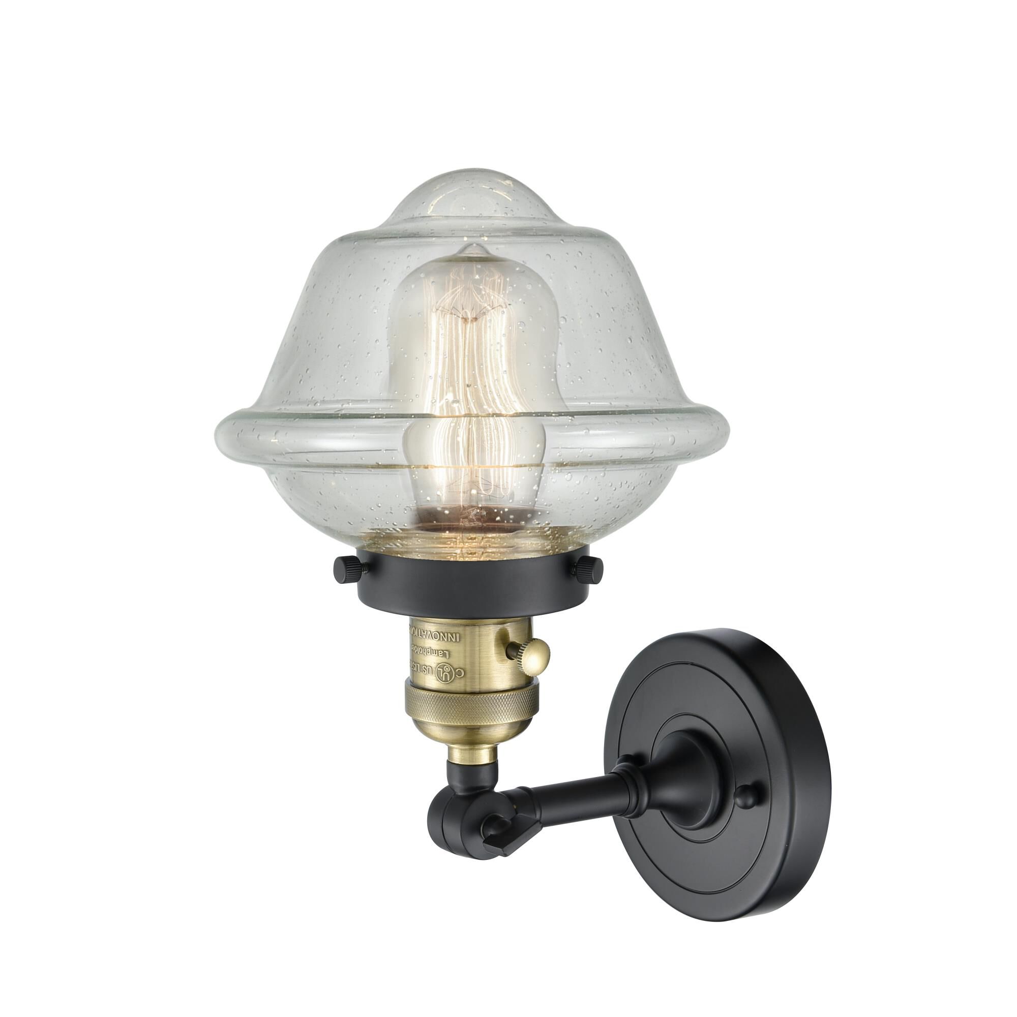 Shown in Black Antique Brass finish and Seedy glass and Switch on Socket accent