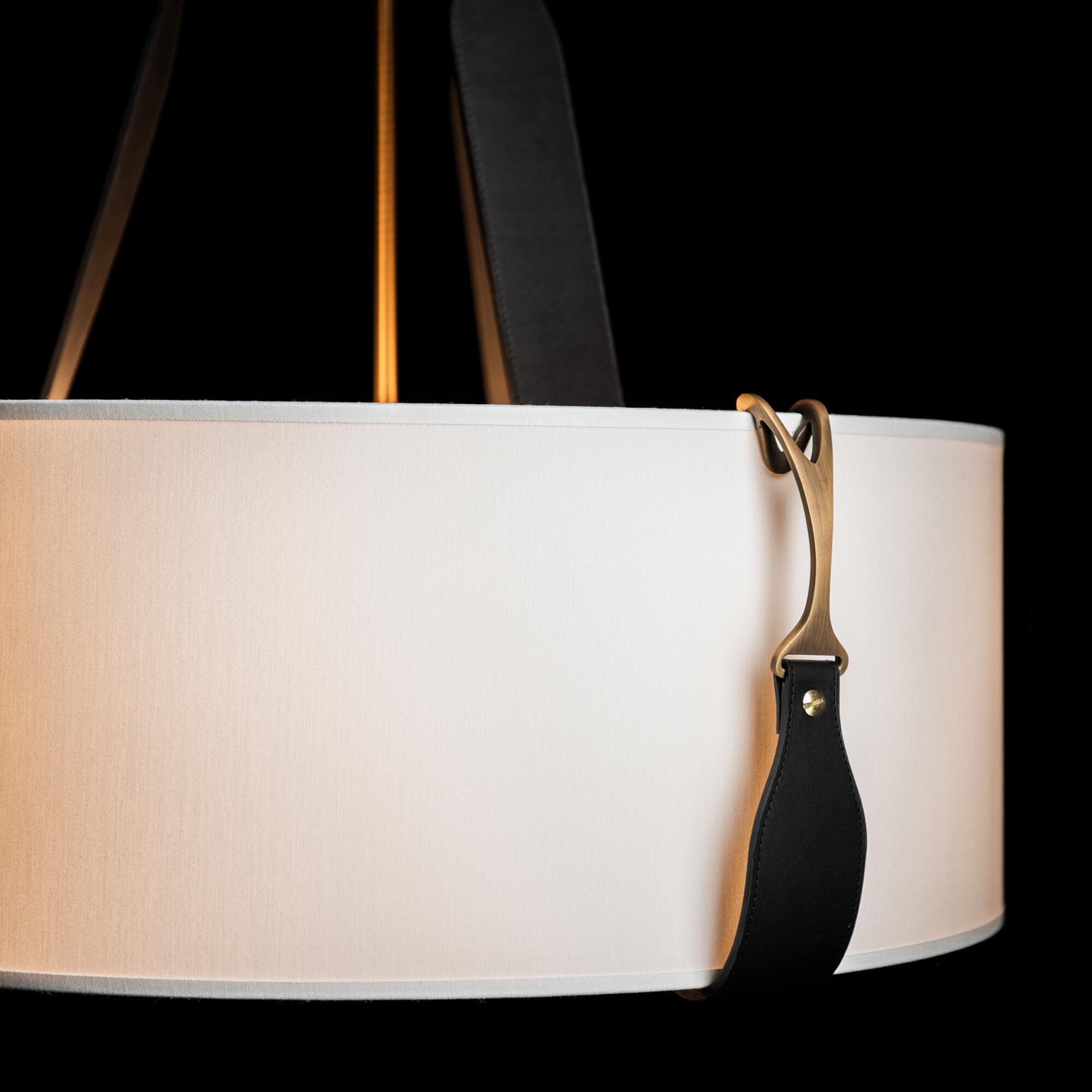 Shown in Antique Brass finish and Natural Anna shade and Leather Black accent