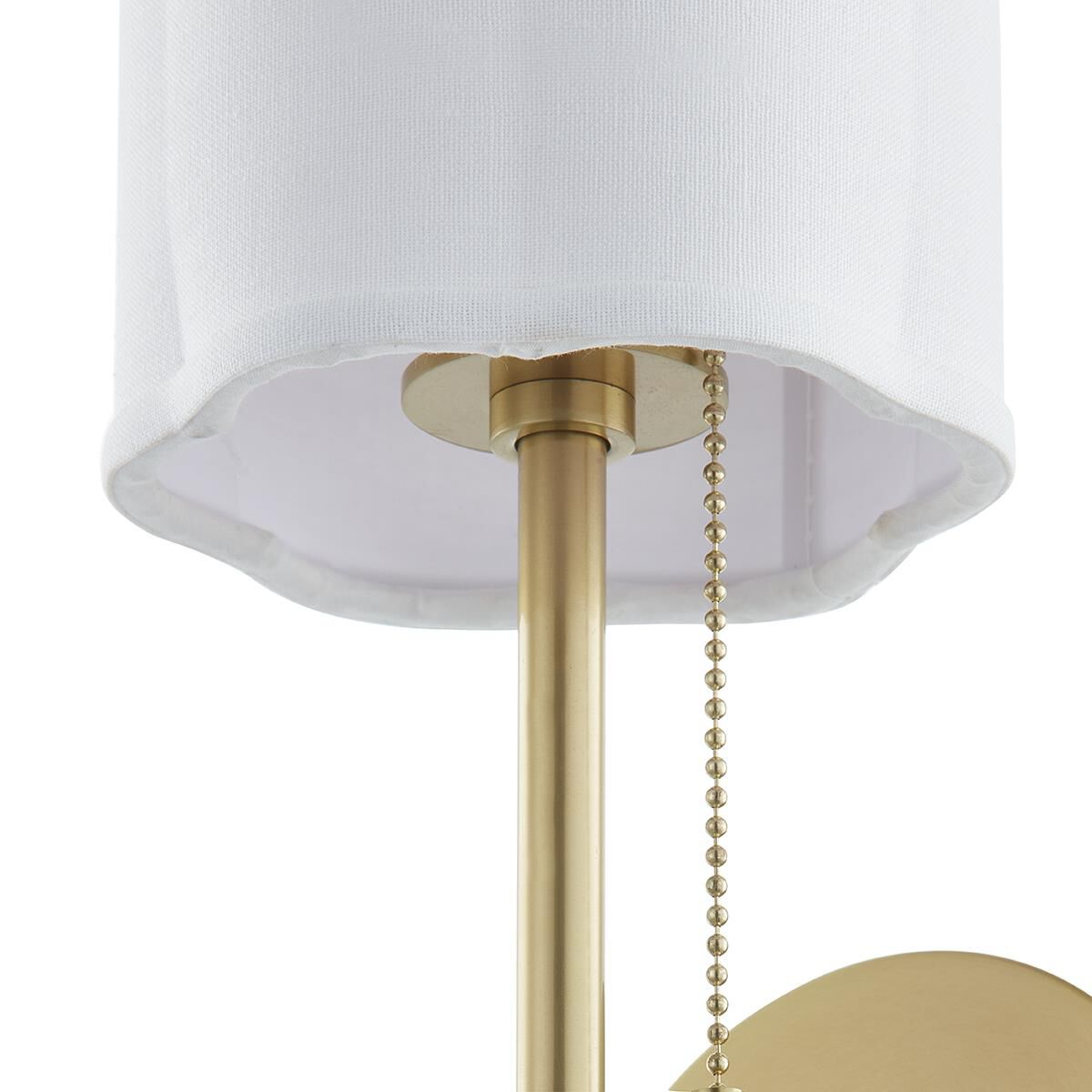 Shown in Aged Brass finish and White Linen shade