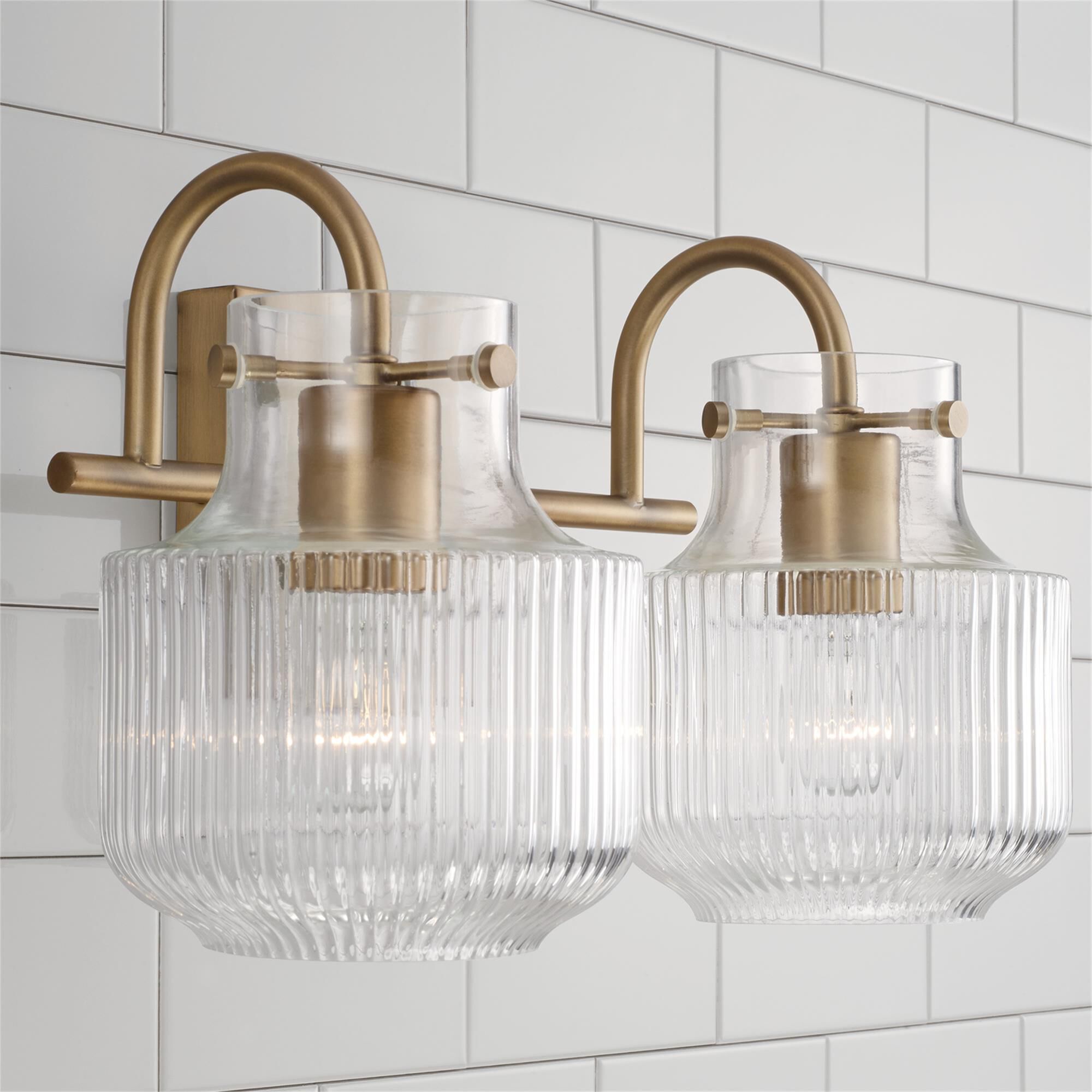 Shown in Aged Brass finish and Clear Fluted glass
