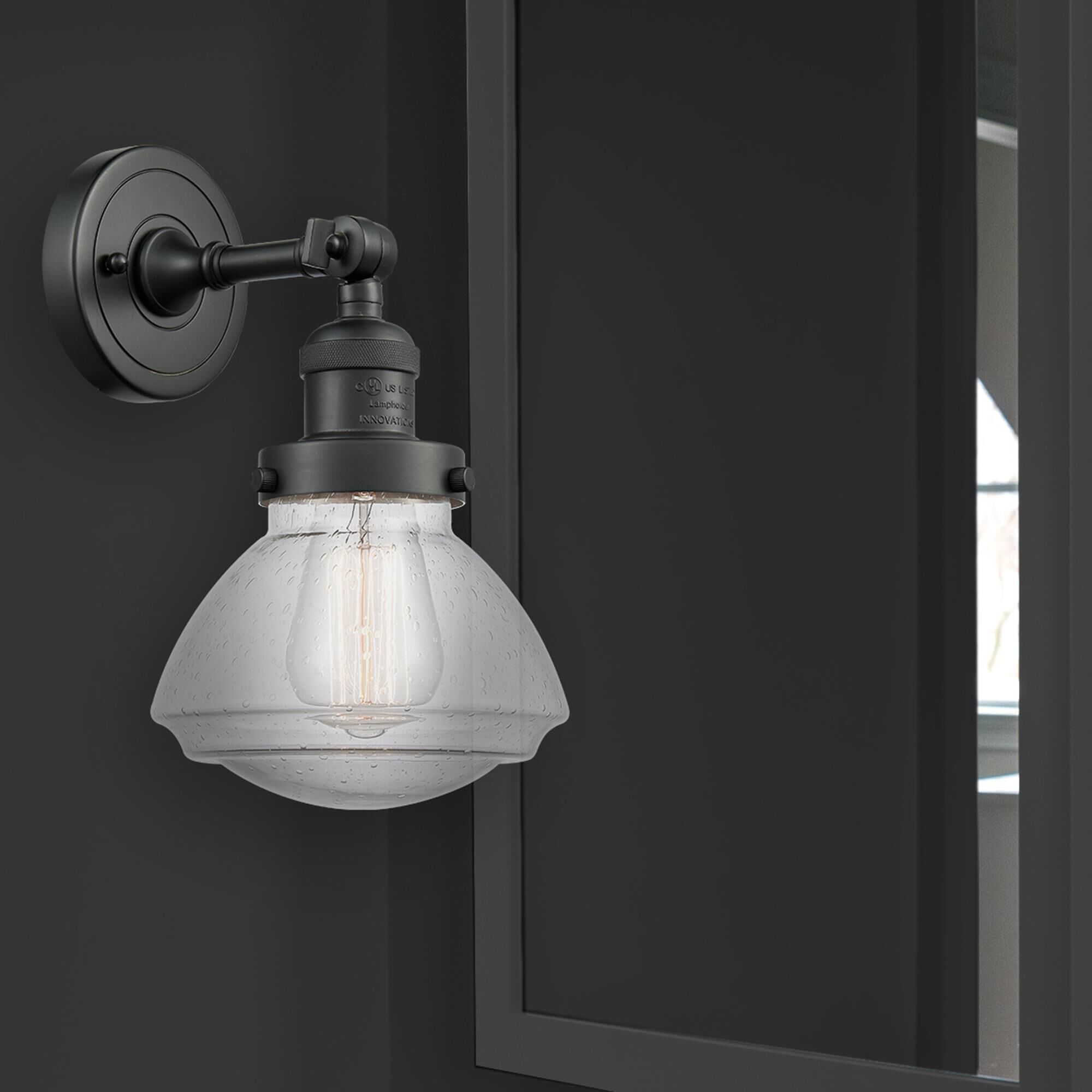 Shown in Matte Black finish and Seeded Seedy Olean glass and Glass shade and Bulb Tint - Amber accent
