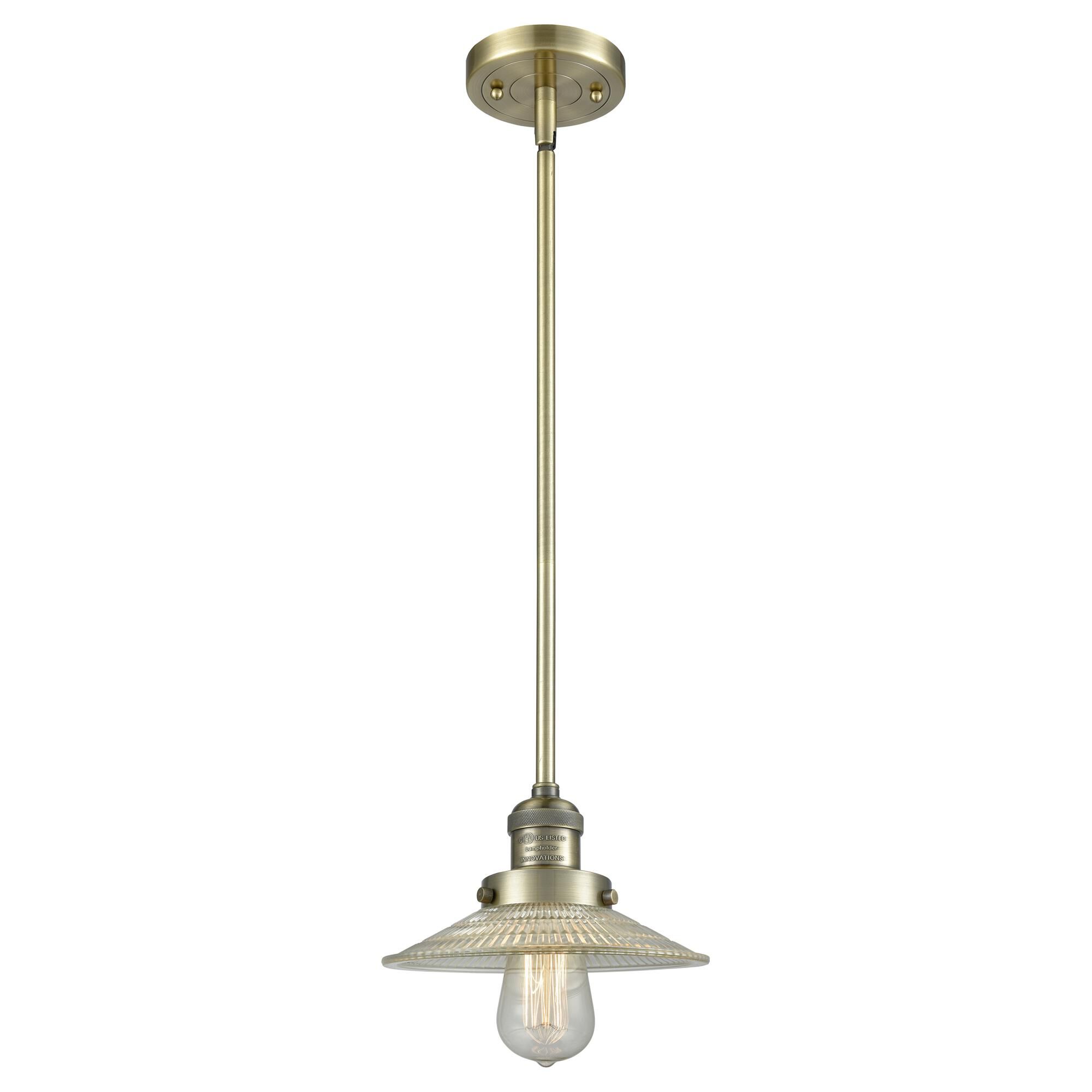 Shown in Antique Brass finish and Clear Halophane glass