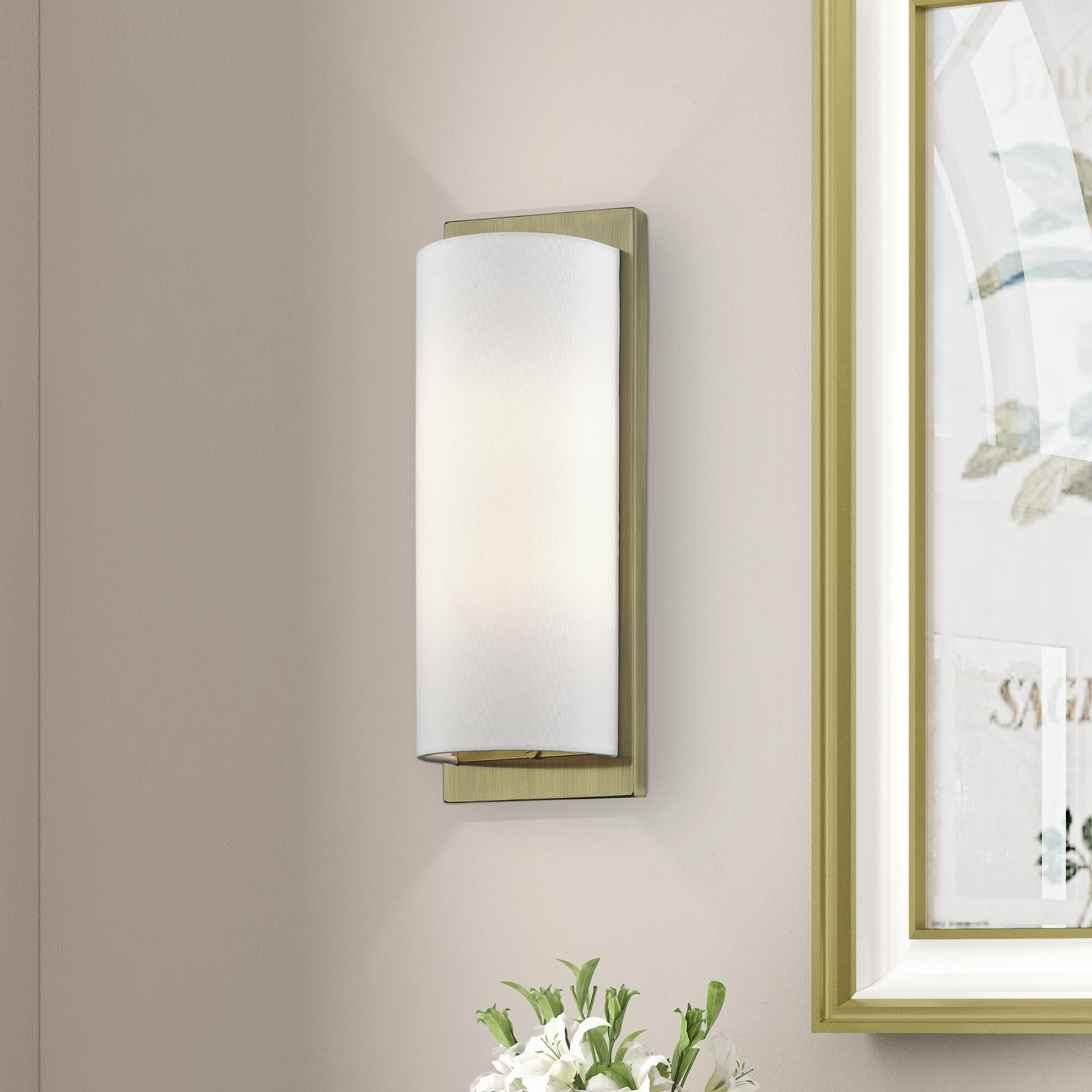Shown in Antique Brass finish and Hand Crafted Off-White Fabric Hardback shade