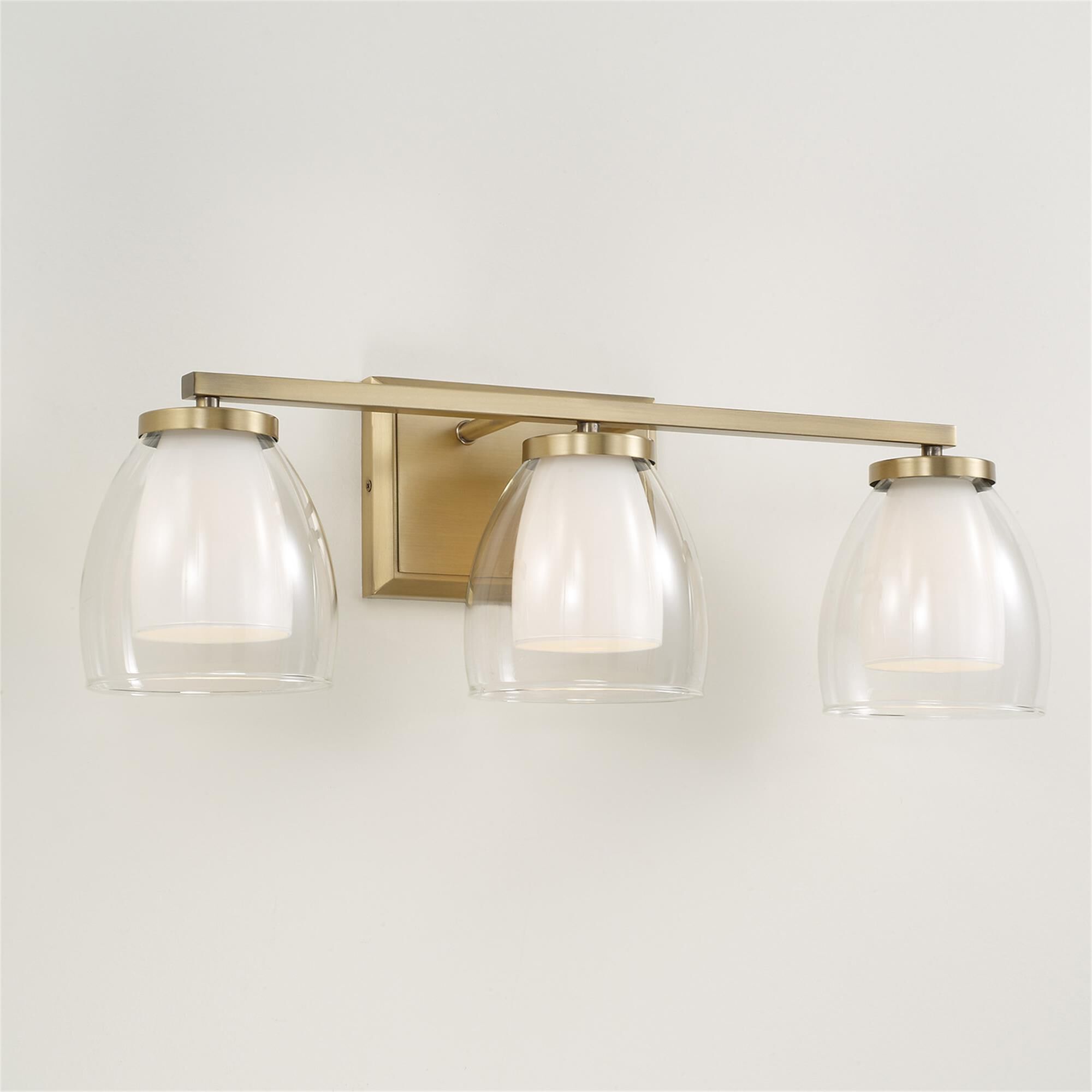 Shown in Aged Brass finish and Layered White And Clear glass