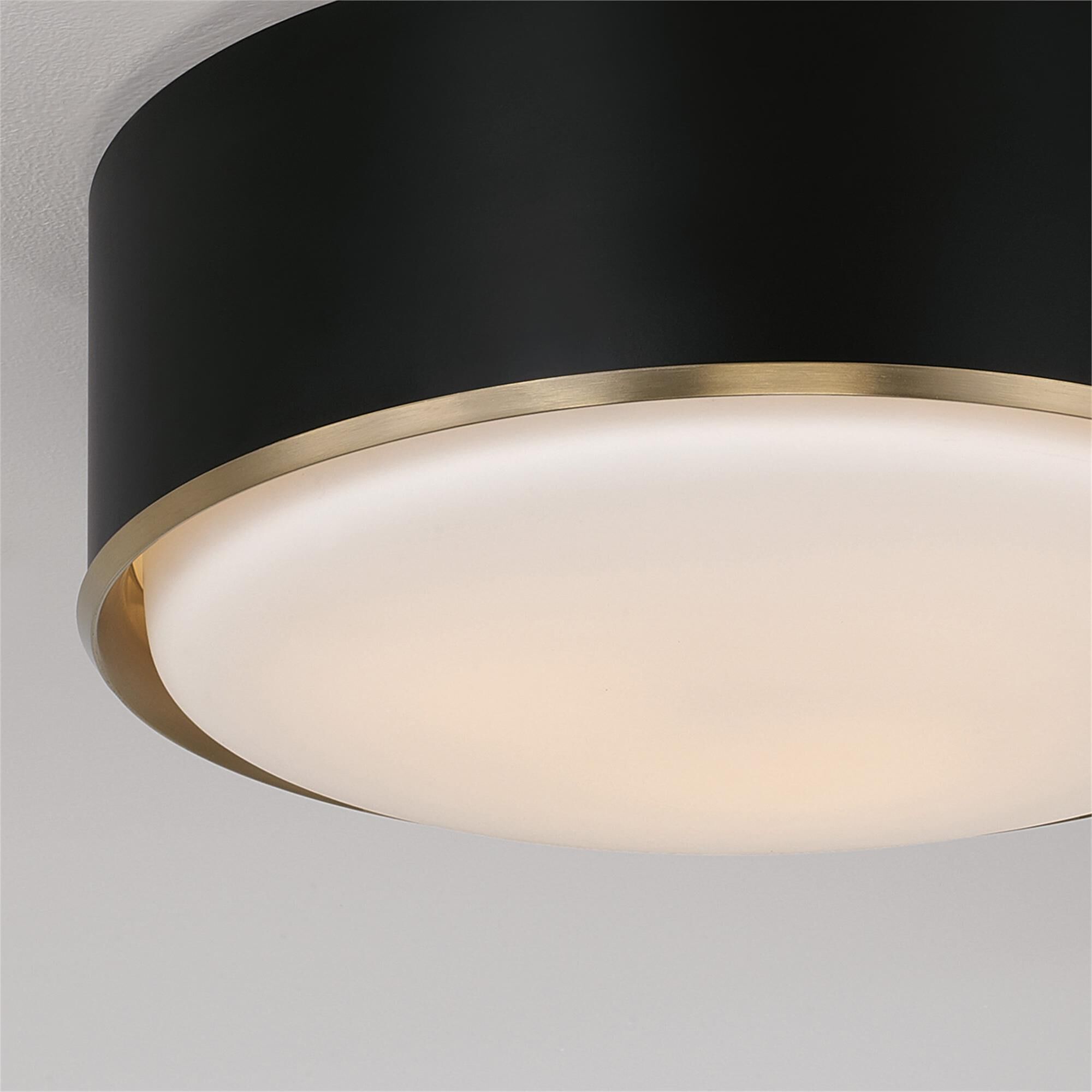 Shown in Matte Brass And Black finish and Soft White glass