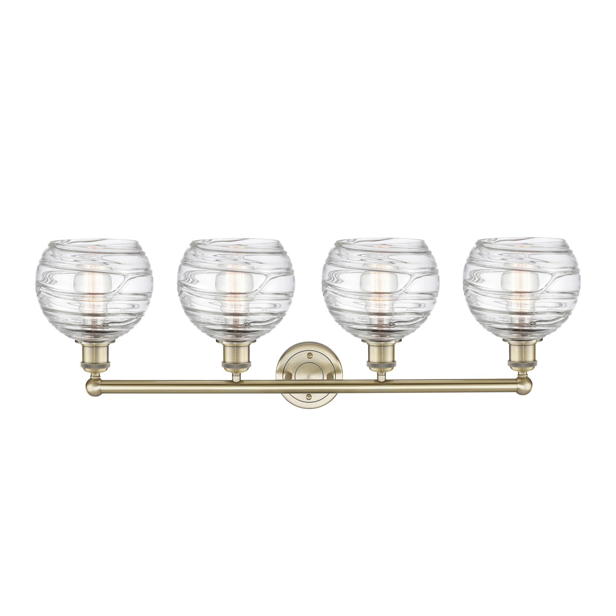 Shown in Antique Brass finish and Clear Deco Swirl glass