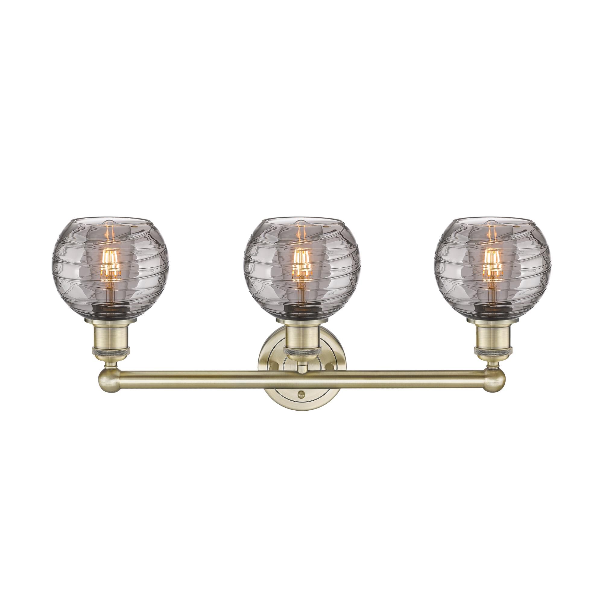 Shown in Antique Brass finish and Light Smoke Deco Swirl glass