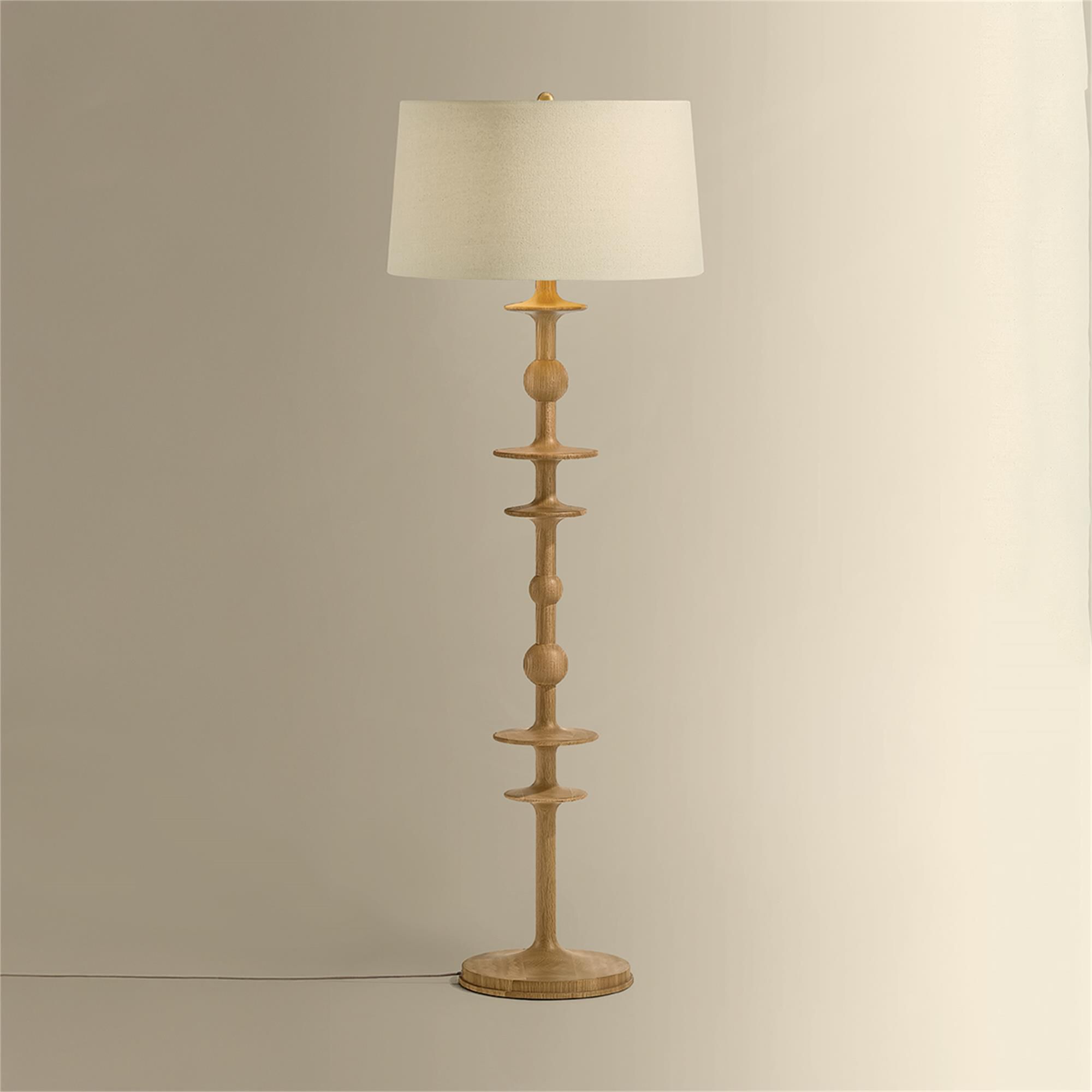 Shown in Aged Brass finish and Wheat Linen shade