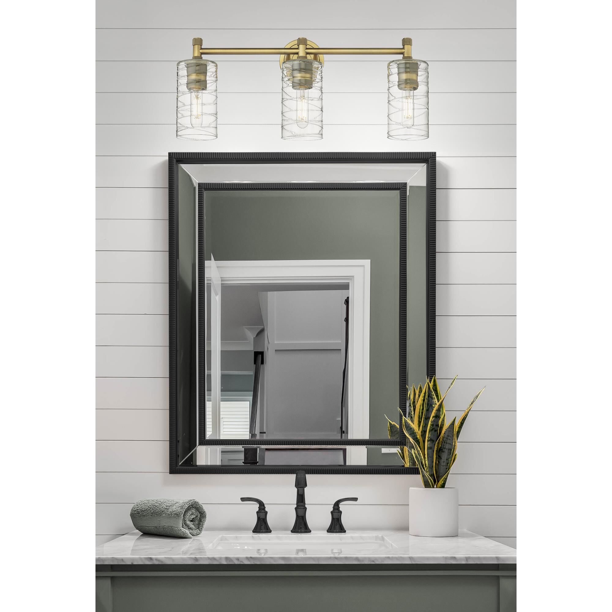 Shown in Brushed Brass finish and Deco Swirl glass