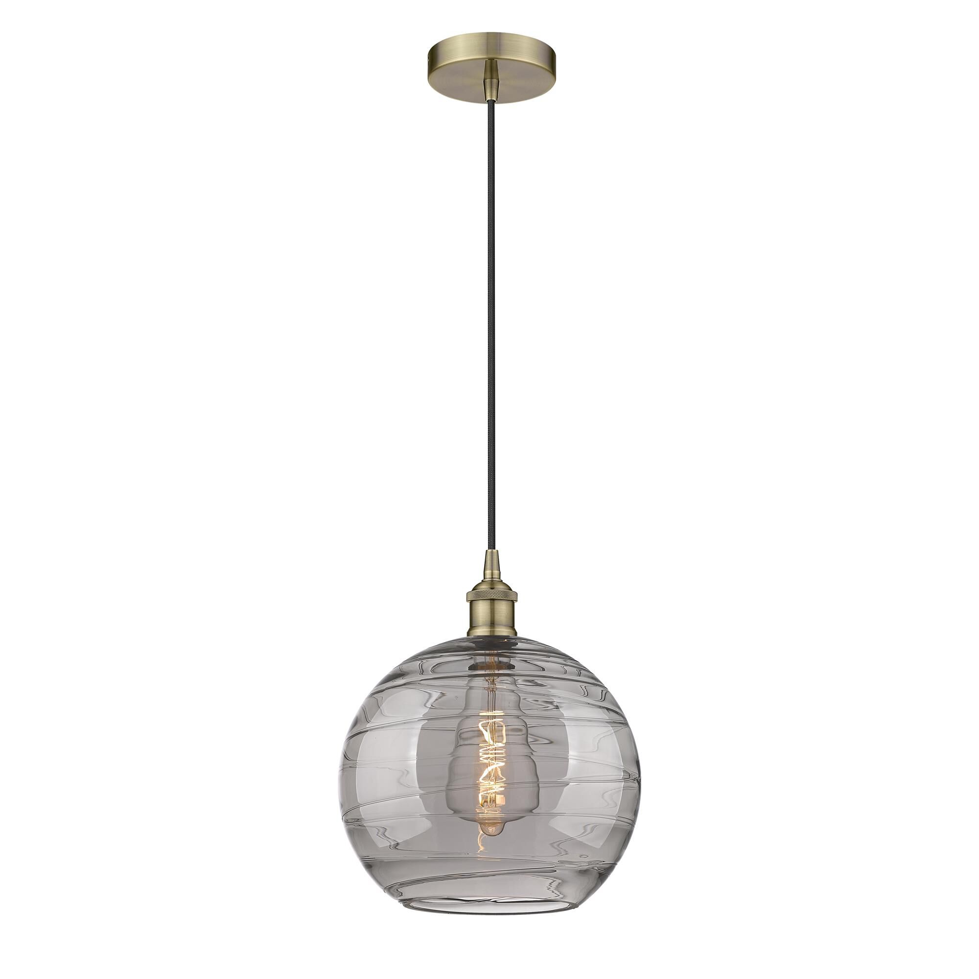 Shown in Antique Brass finish and Light Smoke Deco Swirl glass