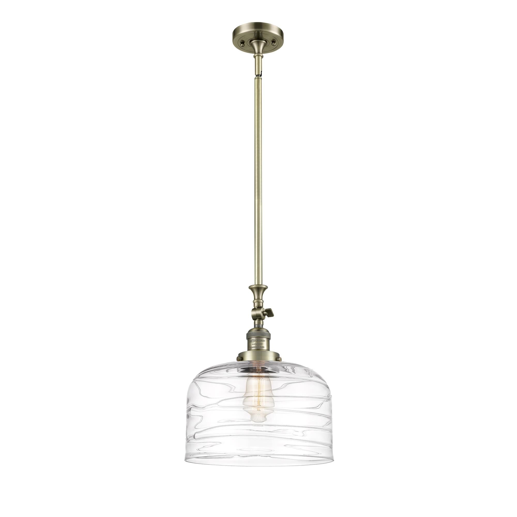 Shown in Antique Brass finish and Clear Deco Swirl X-Large Bell glass