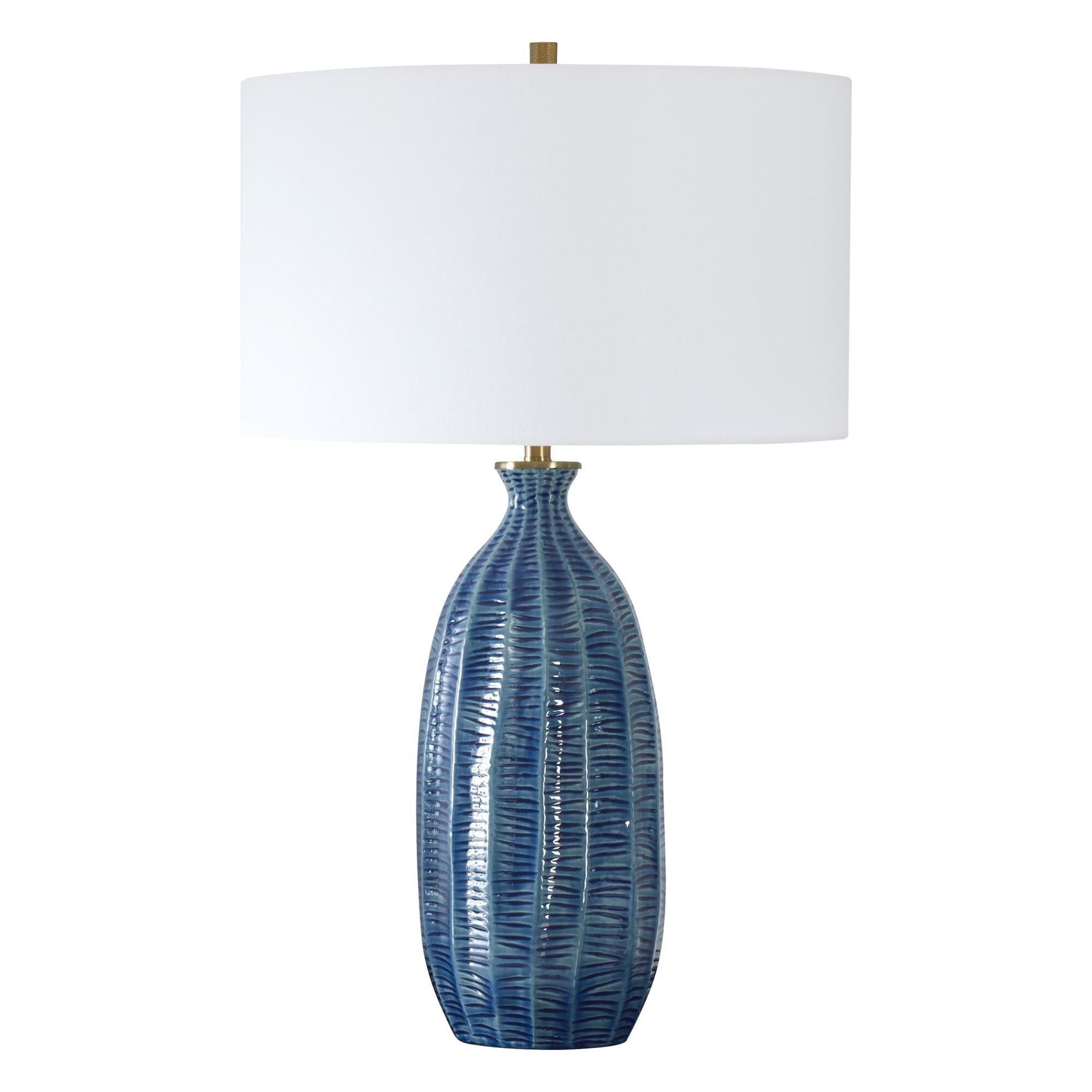 Shown in Where Coastal Charm Meets Refined Elegance, Featuring A Heavily Textured Ceramic Base In A Rich Blue finish and Drum With Liner shade