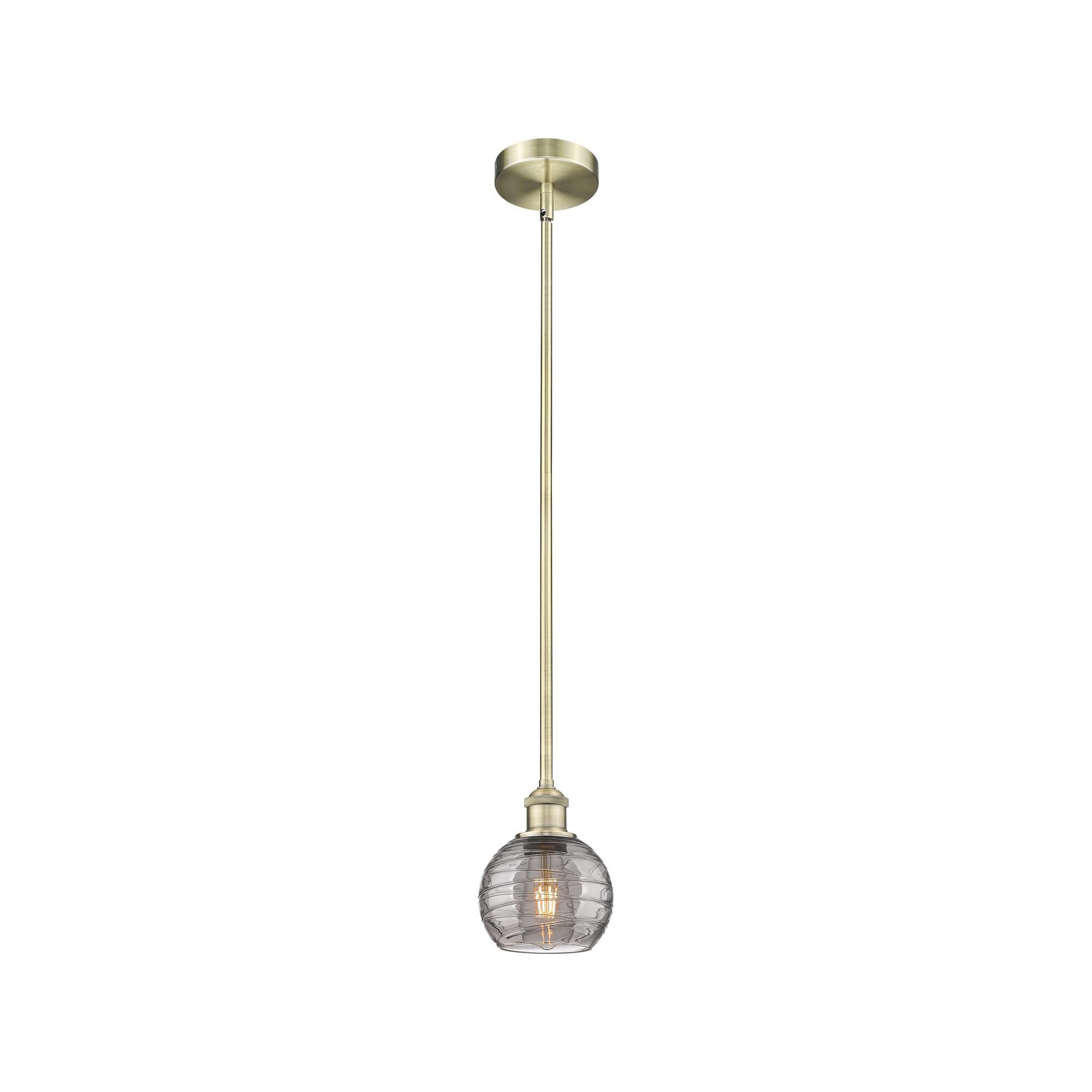Shown in Antique Brass finish and Light Smoke Deco Swirl glass