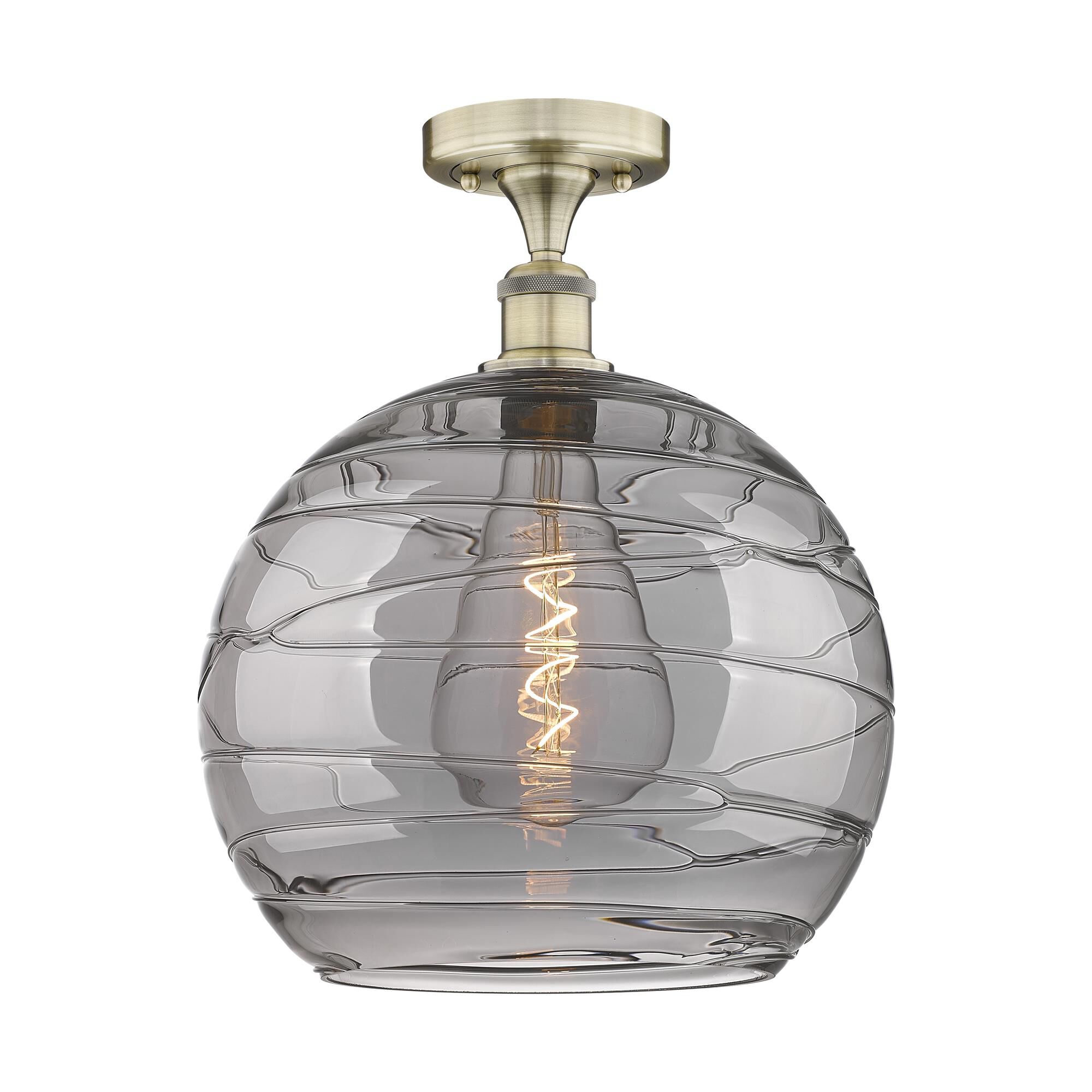Shown in Antique Brass finish and Light Smoke Deco Swirl glass
