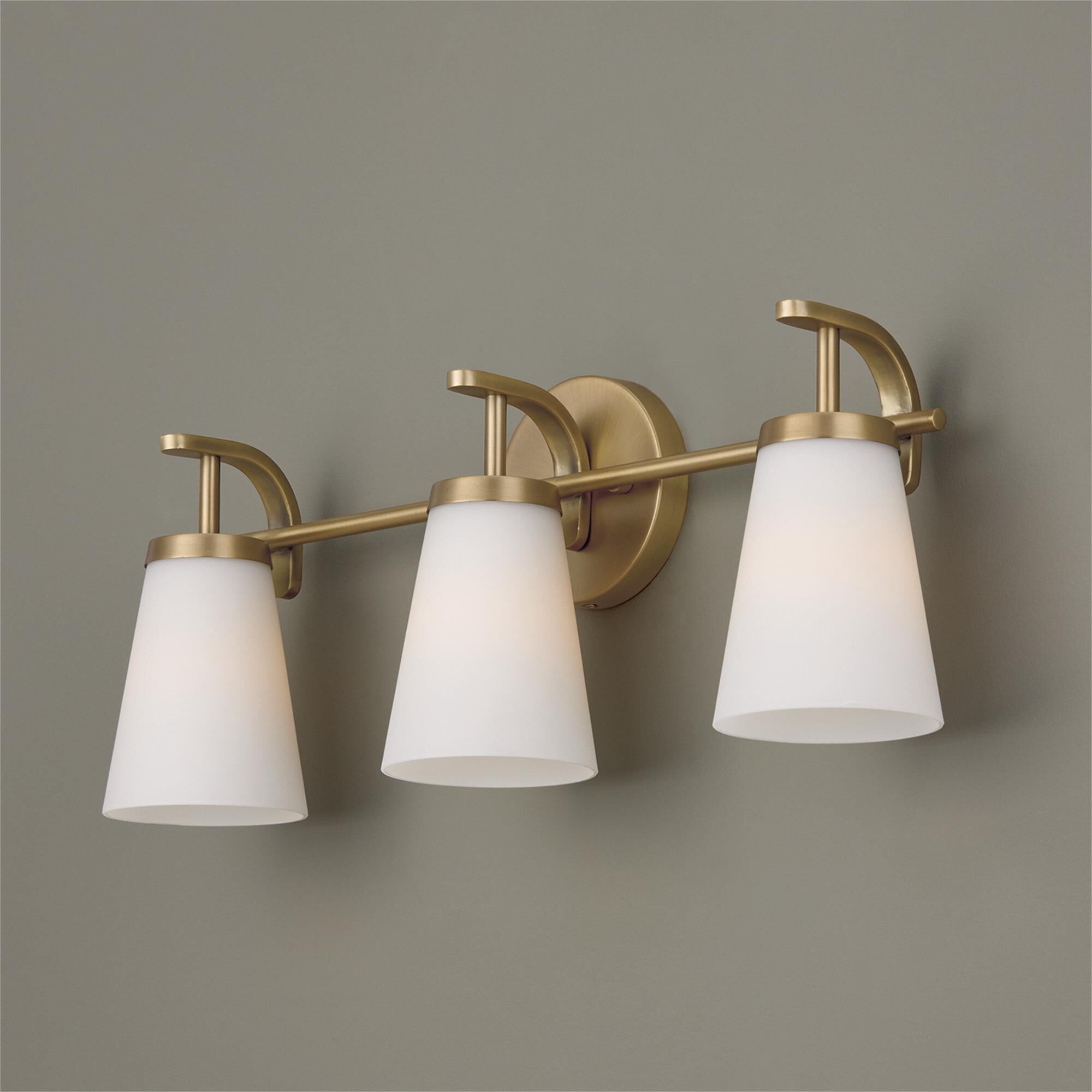 Shown in Aged Brass finish and Soft White glass