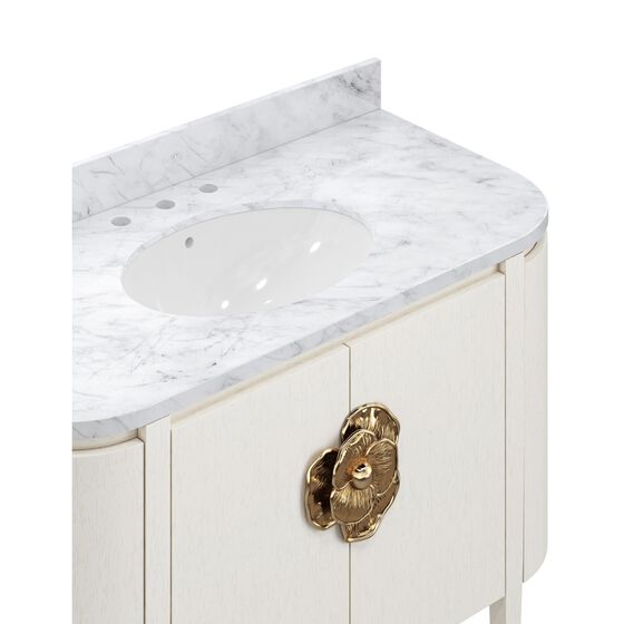 White bathroom vanity with marble top and brass hardware.