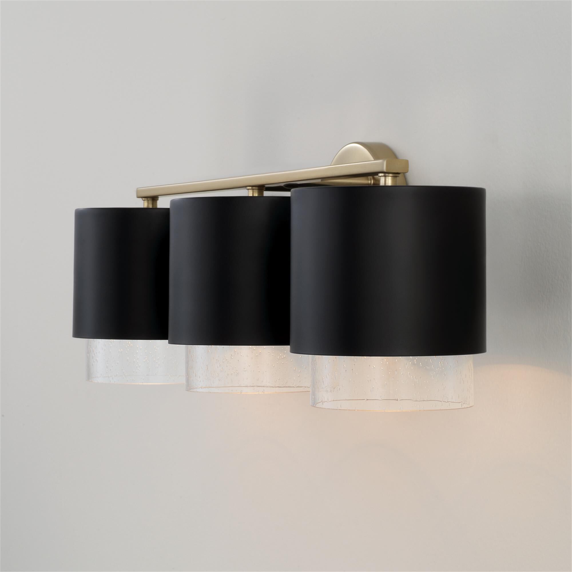 Shown in Matte Brass and Black finish and Clear Seeded glass and Metal with Brass Interior shade