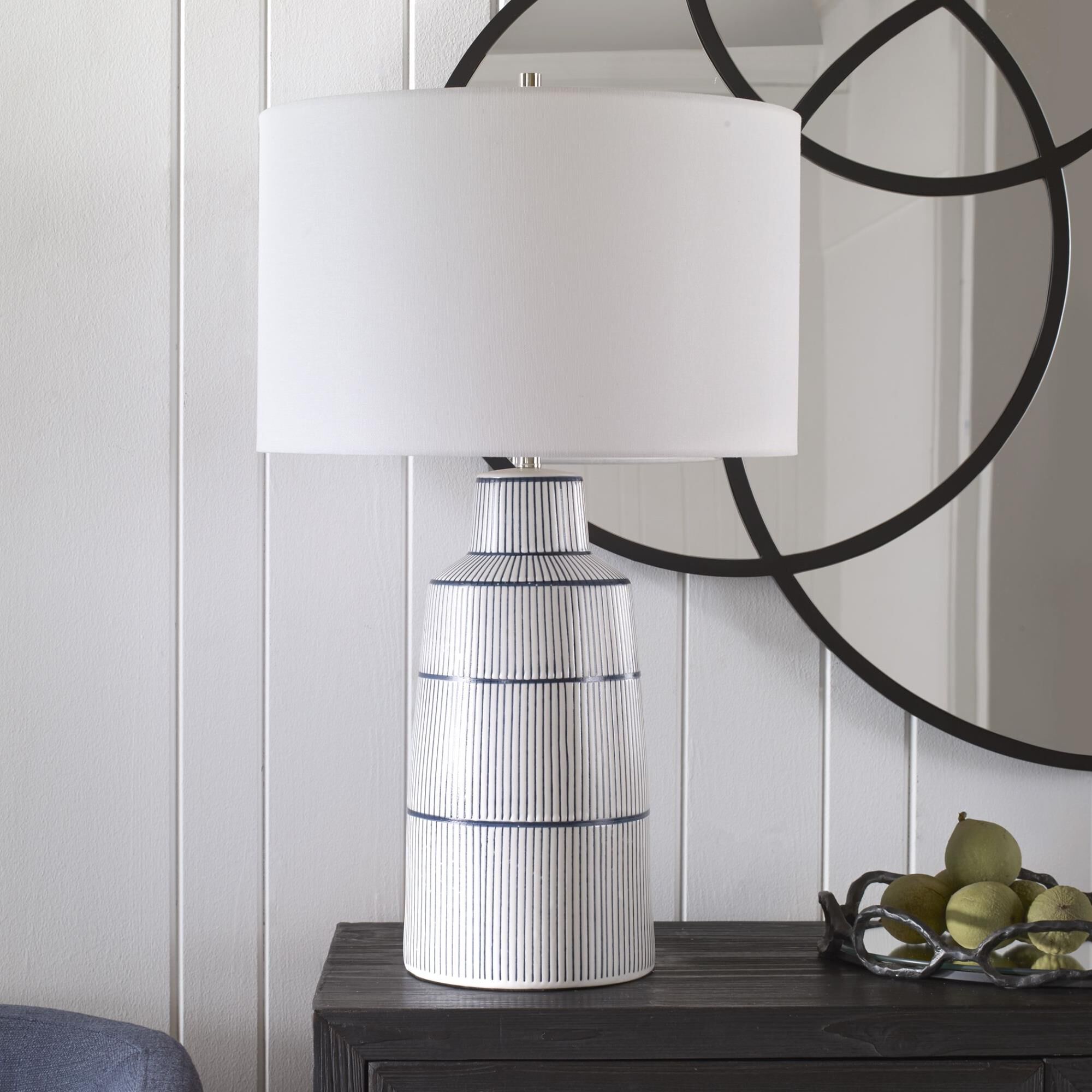 Shown in Inspired By The Classic Nautical Stripe Knit, This Ceramic Table Lamp Sports A Satin White Glaze Wit finish and Round Hardback Drum shade