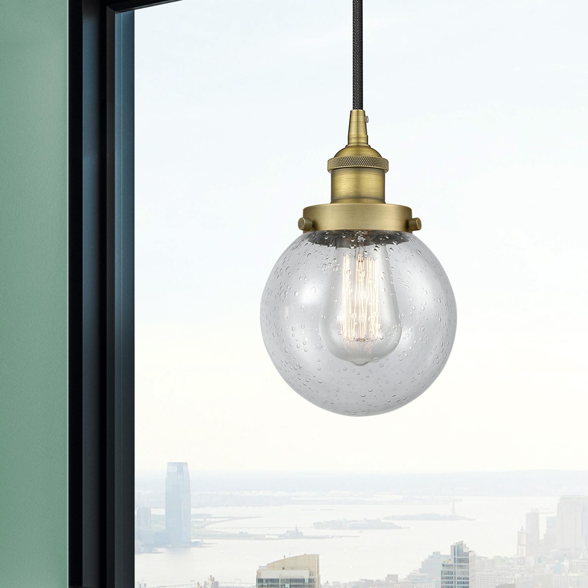 Shown in Brushed Brass finish and Seedy glass