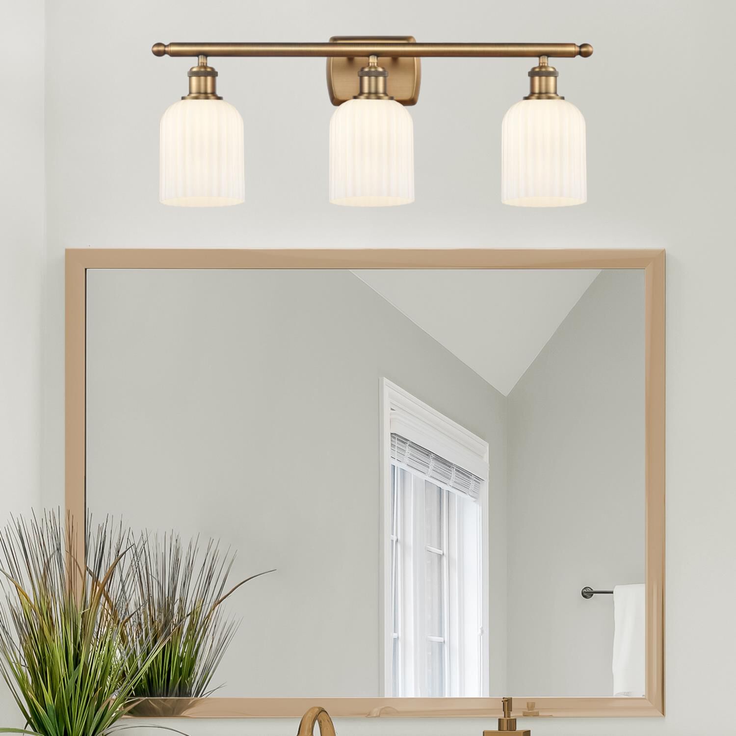 Shown in Brushed Brass finish and Gloss White glass