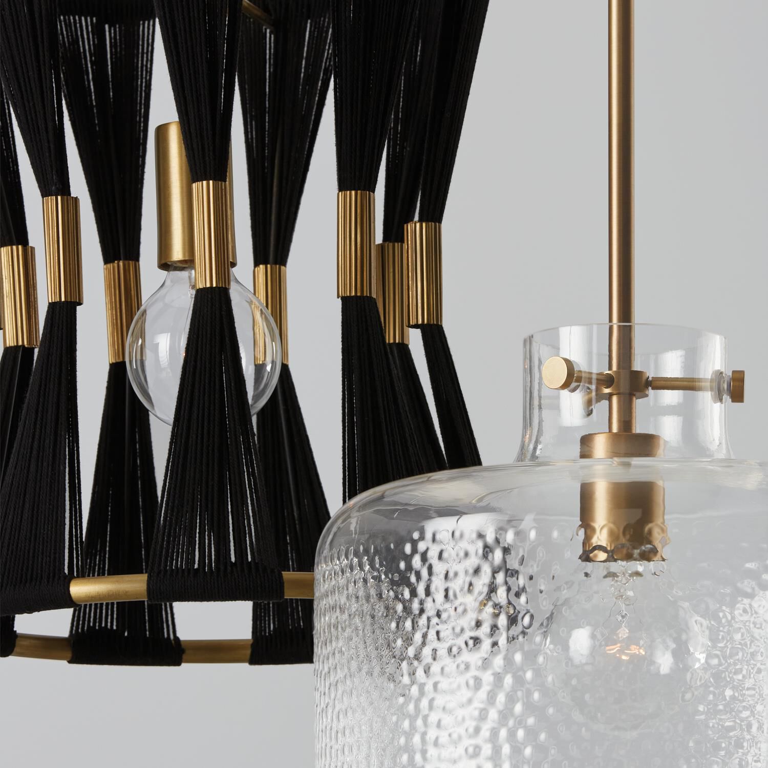 Shown in Aged Brass finish and Clear Pebbled glass