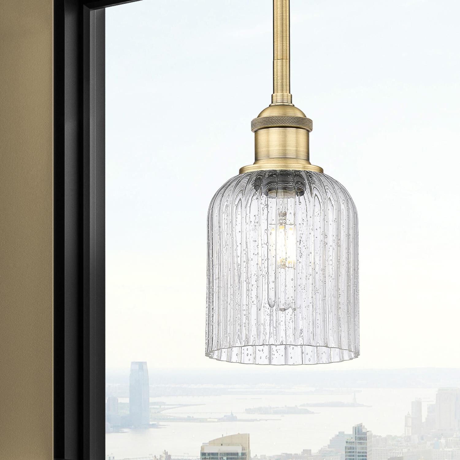 Shown in Brushed Brass finish and Seedy glass