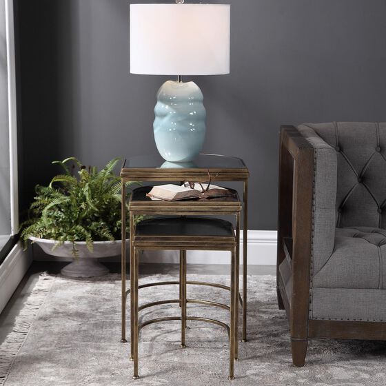 Round accent table with a lamp in a living room.