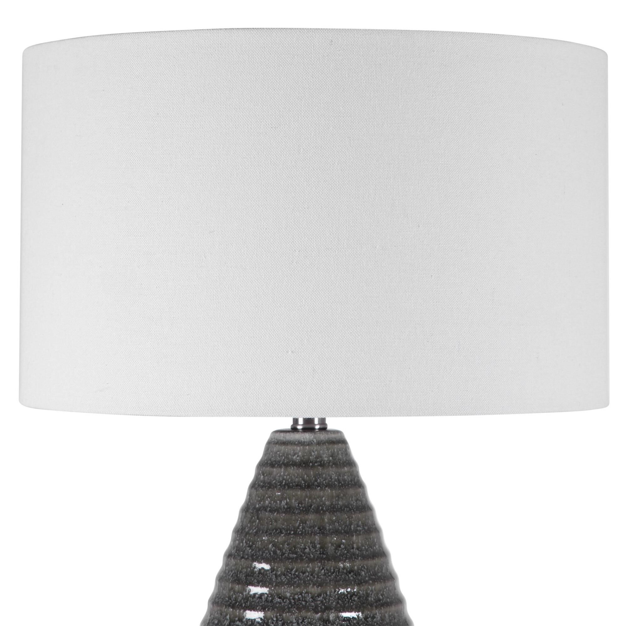 Shown in Showcasing A Tapered Ceramic Base With Ribbed Texture, This Transitional Table Lamp Is Finished In A finish and Round Hardback Drum shade