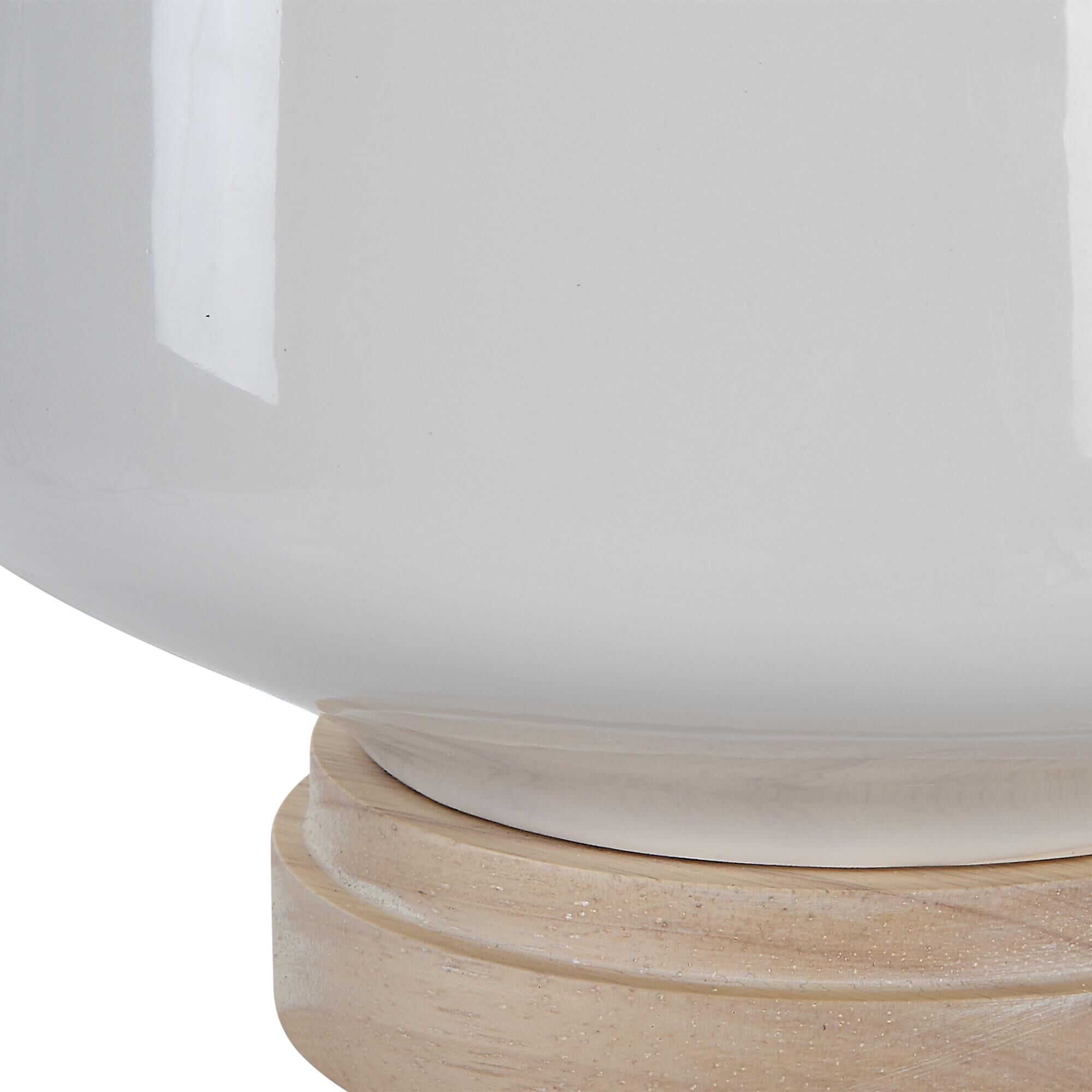 Shown in This Ceramic Table Lamp Featuring A White High Gloss Glaze Accented By Brushed Nickel Finishes. The  finish and Round Hardback shade