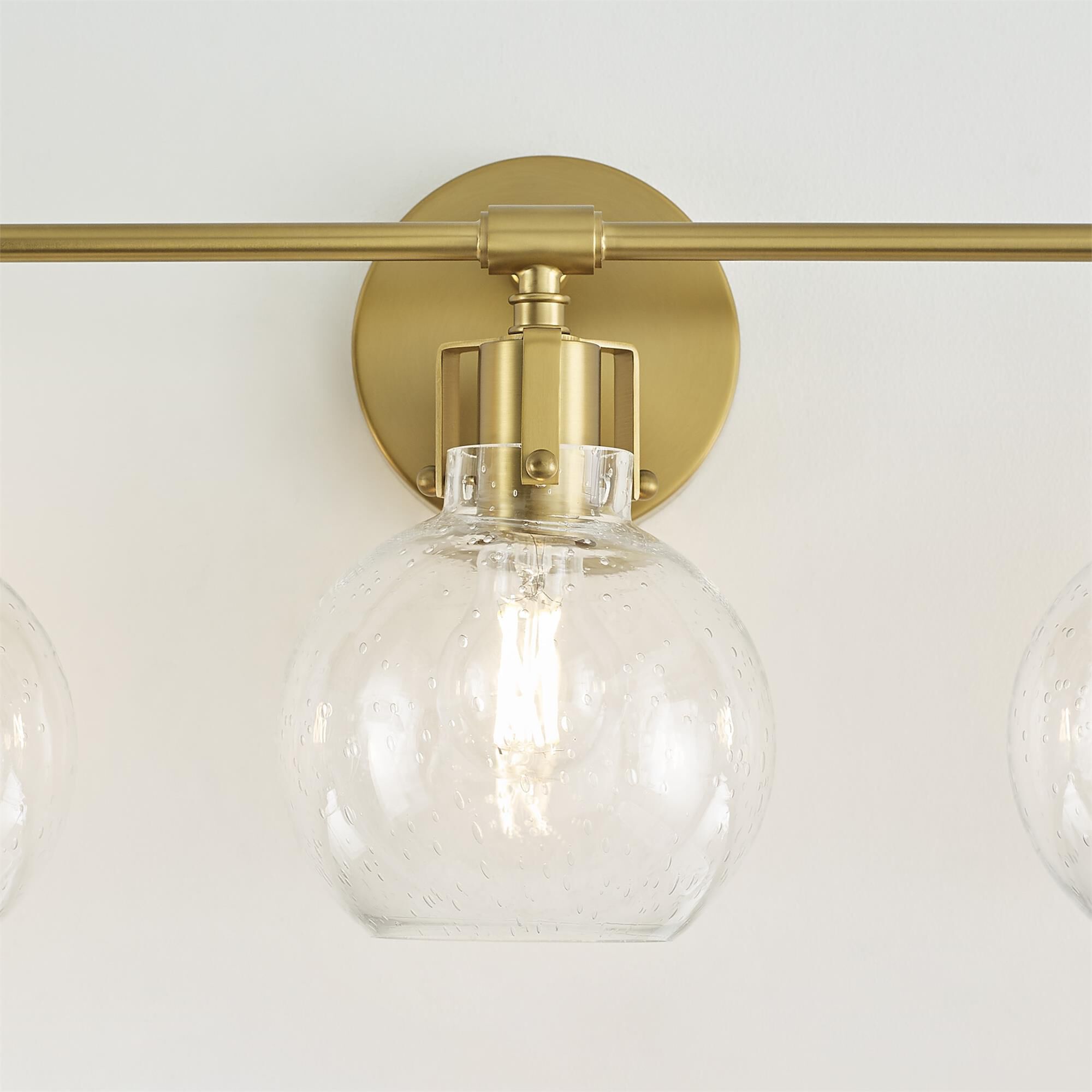Shown in Burnished Brass finish and Clear Seeded glass