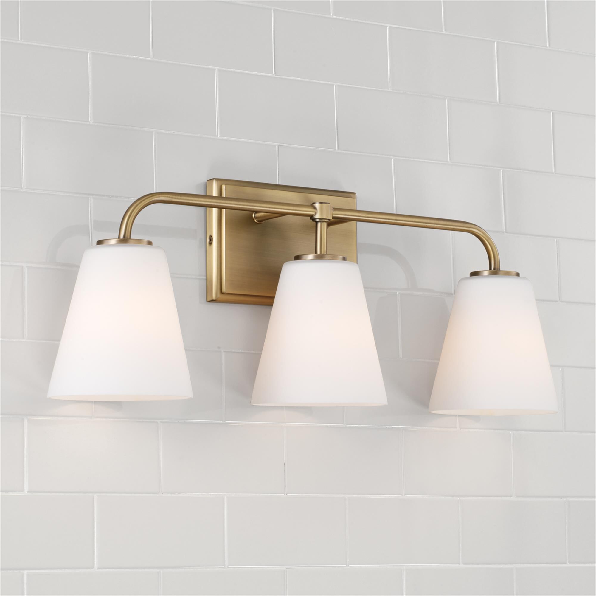 Shown in Aged Brass finish and Soft White glass