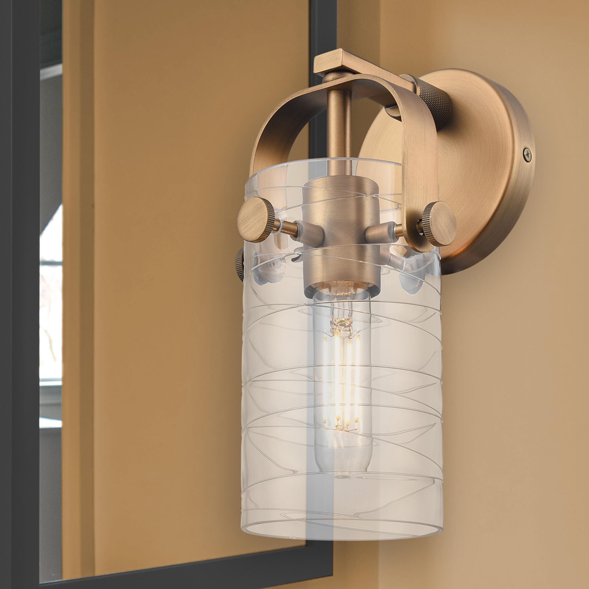 Shown in Brushed Brass finish and Deco Swirl glass