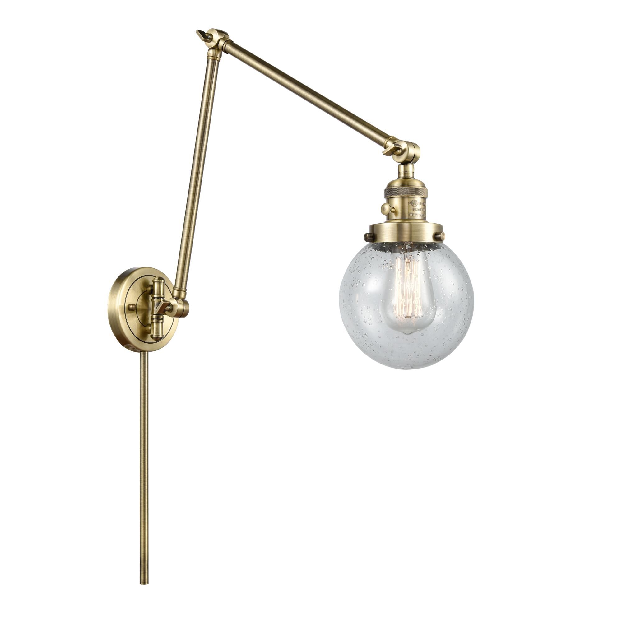 Shown in Antique Brass finish and Seedy Beacon glass