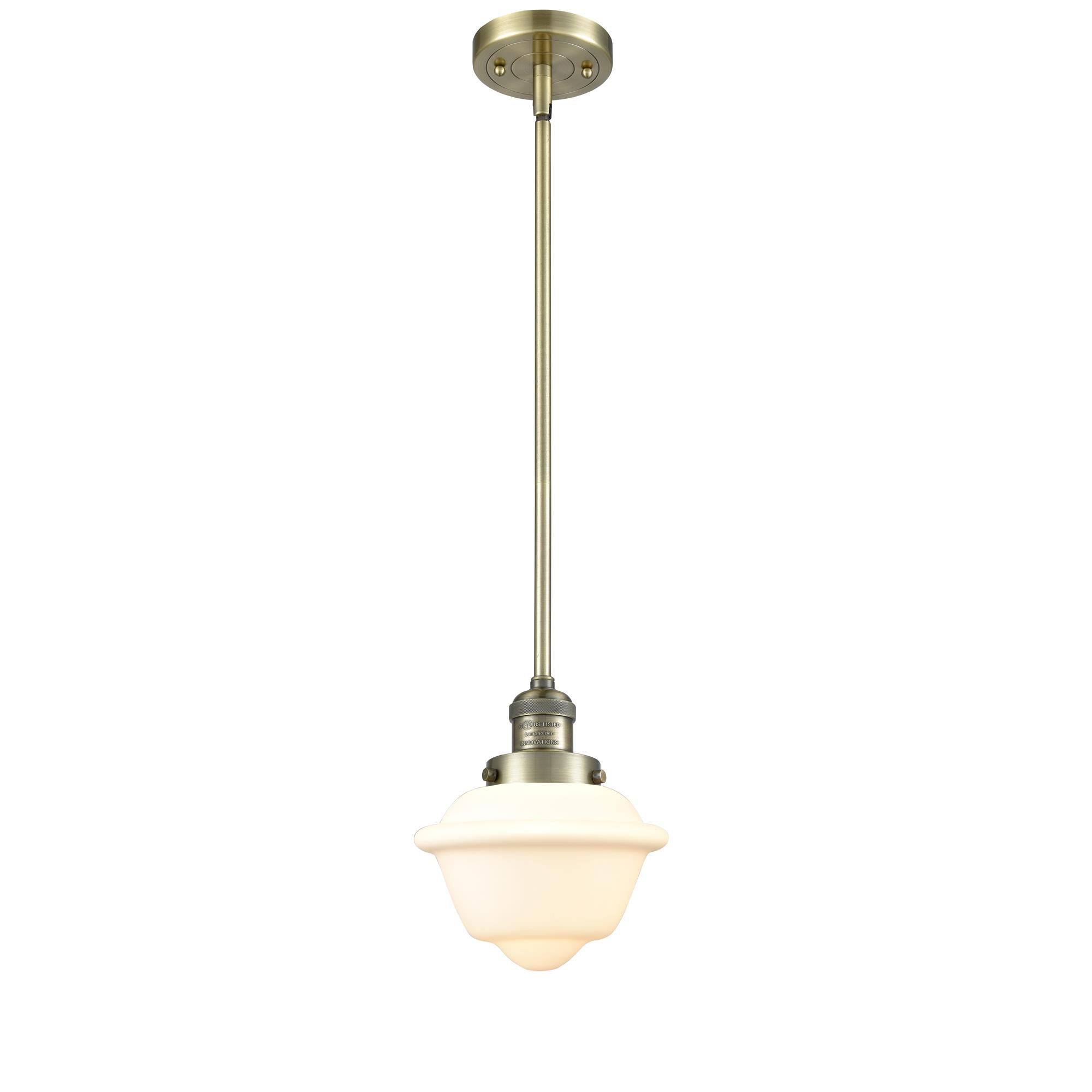 Shown in Antique Brass finish and Matte White Cased glass