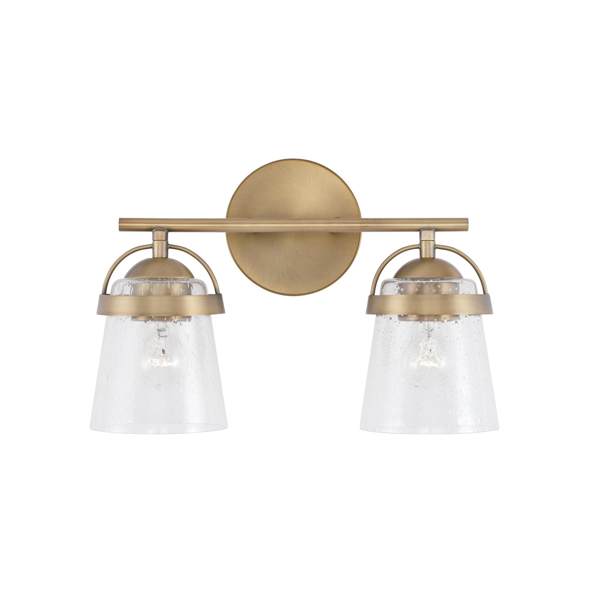 Shown in Aged Brass finish and Clear Seeded glass